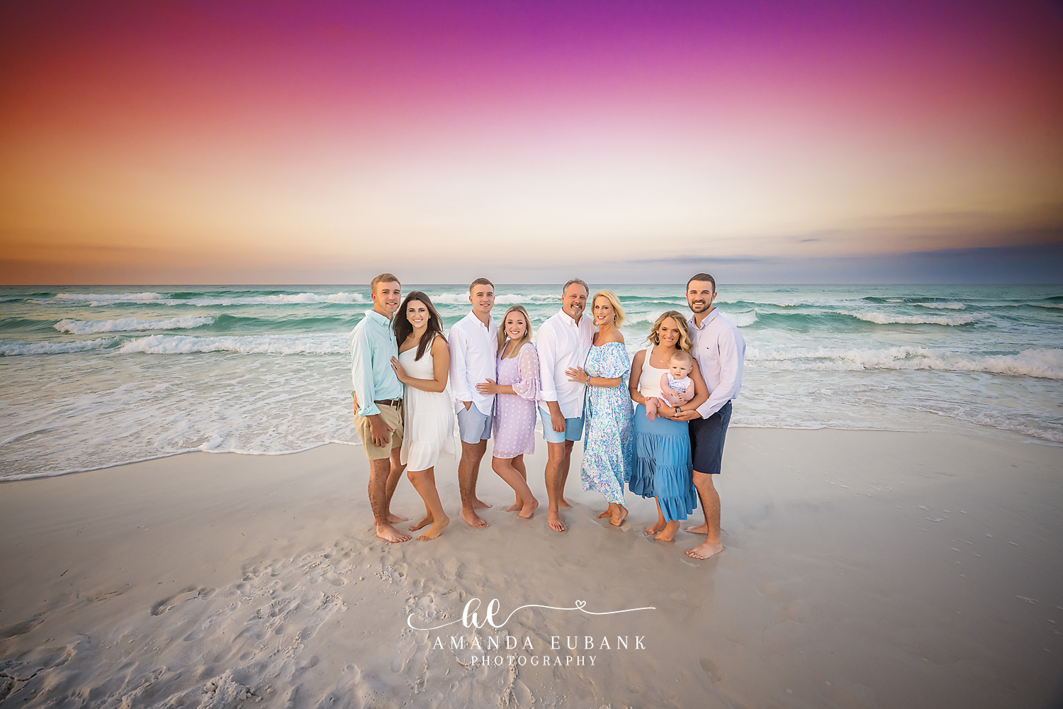 Extended Family on the Shoreline — Tampa Bay Extended Family Session An extended family of nine on the shoreline in blue and white at dusk at a large family beach session in Tampa, FL.