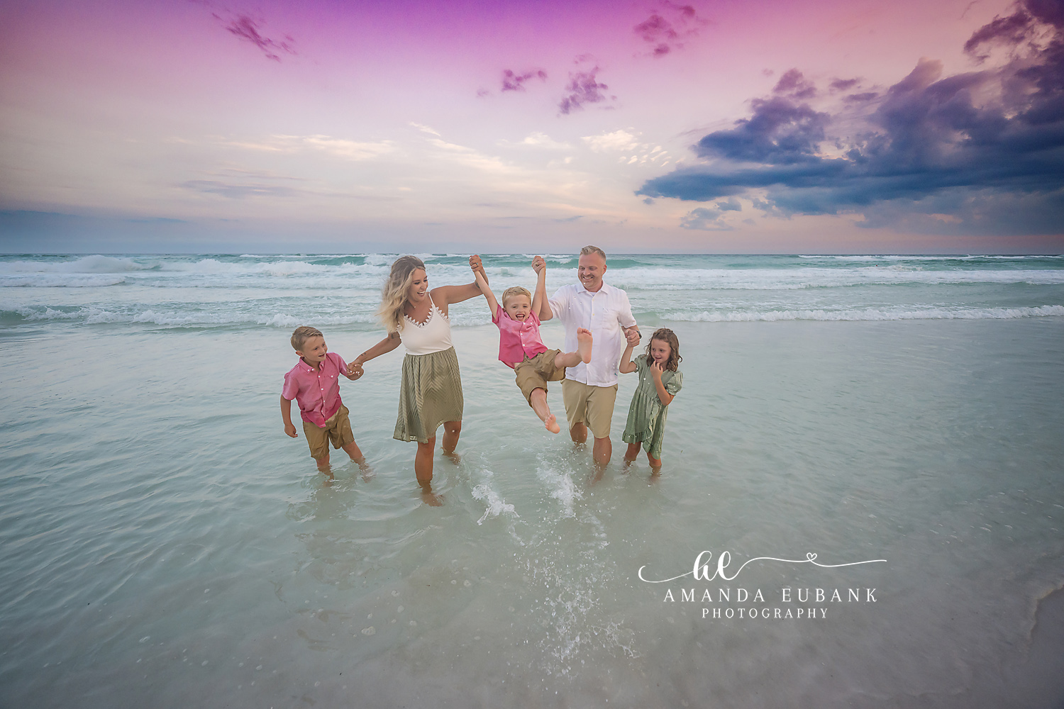 Family Playing in the Shallows | Family Photographer in Tampa, Florida Family beach portraits in Tampa, FL showing a family of six playing and swinging the kids through the shallow water.