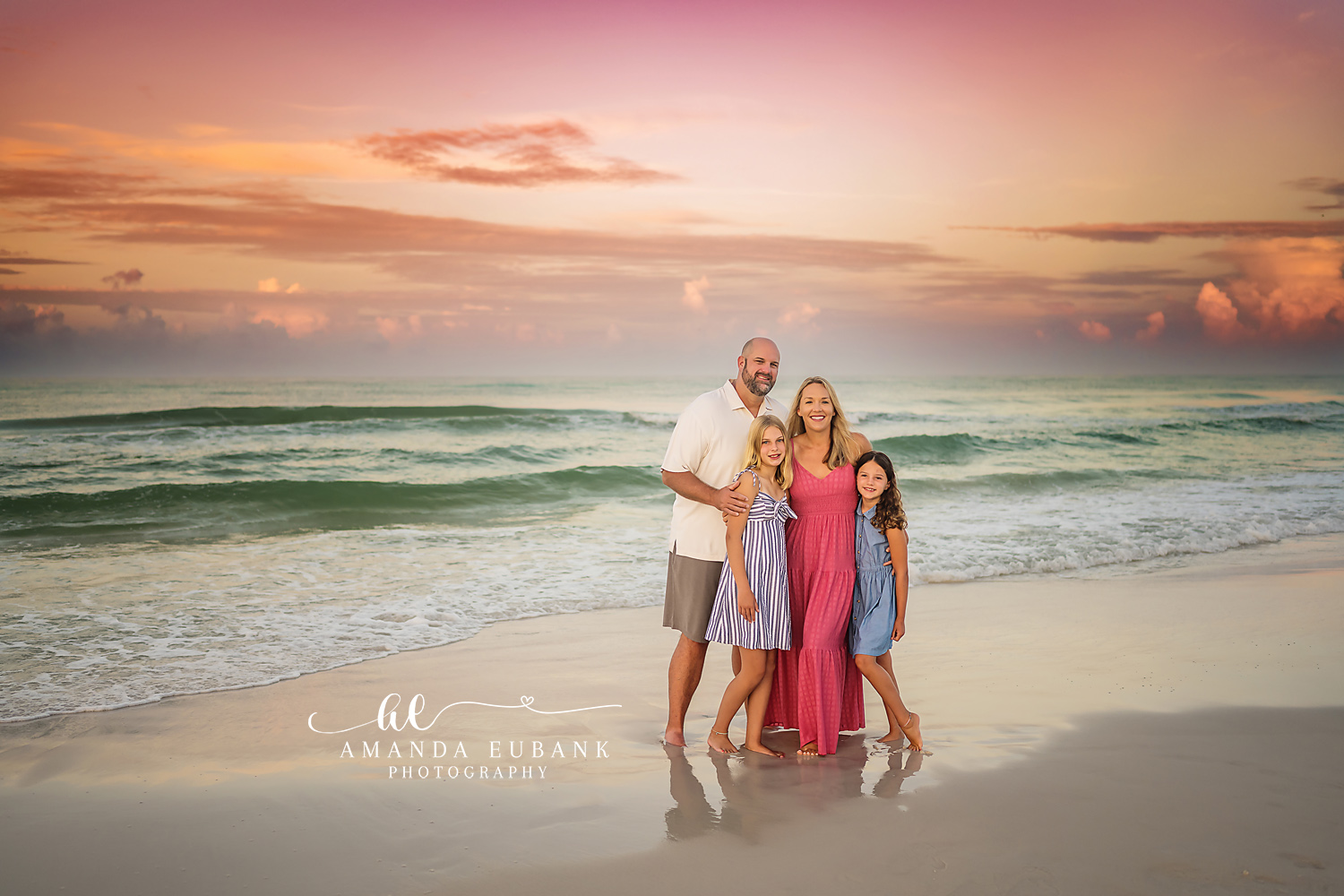 Family of Five in Pink and Blue — Tampa Bay Family Portraits A family of five standing on the shoreline in pink and blue at golden hour — beach family photography in Tampa Bay.