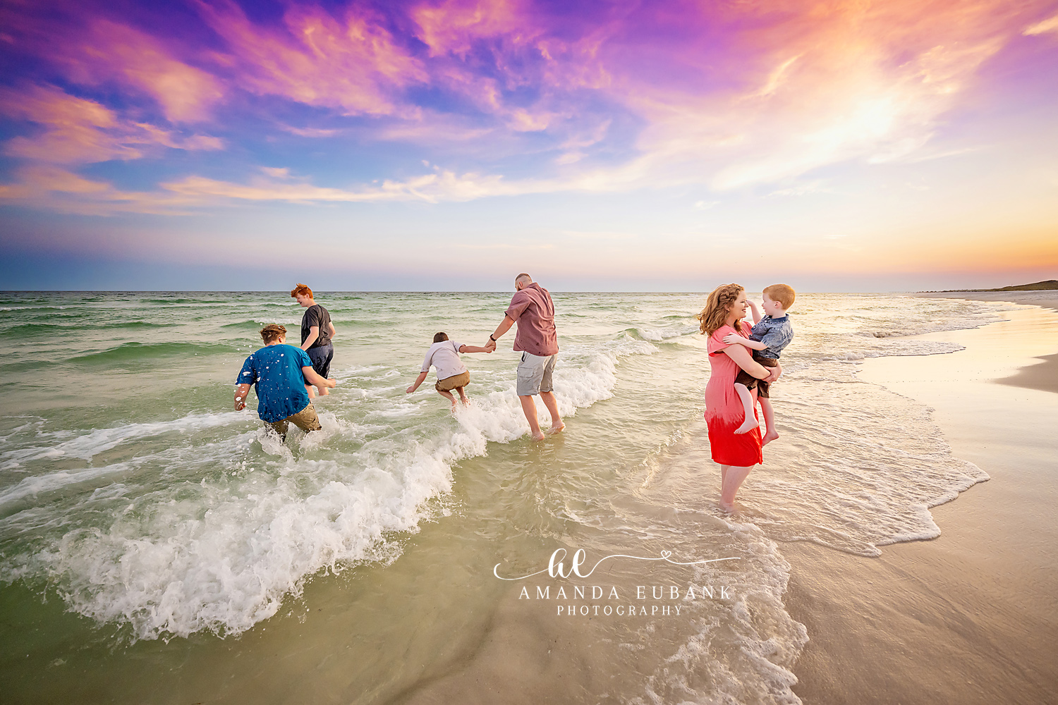 Family Running Through the Surf | Tampa Family Photographer A family of six running and playing through the breaking surf at sunset during a Tampa family photography session.
