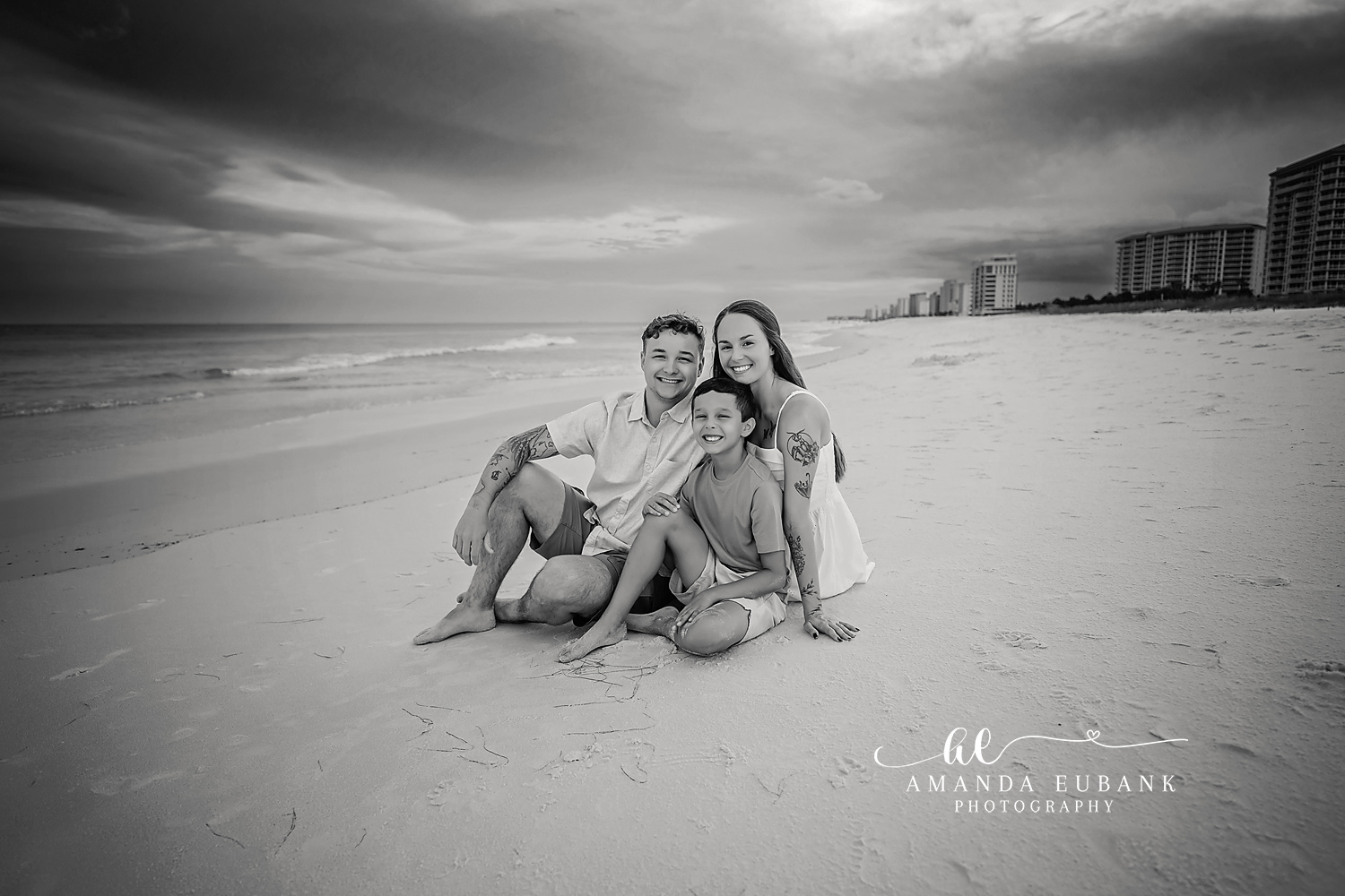 Monochrome Beach Portrait — Tampa Bay Couples Portraits A black and white portrait of a couple sitting on the sand by the shoreline — beach couples photography in Tampa Bay.