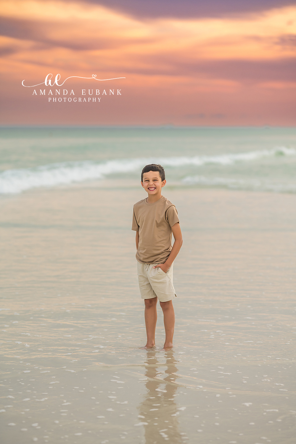 Boy Standing in the Shallows — Tampa Bay Children’s Photography A young boy standing in the shallow water looking out at the Gulf at a beach kids session in Tampa, FL.