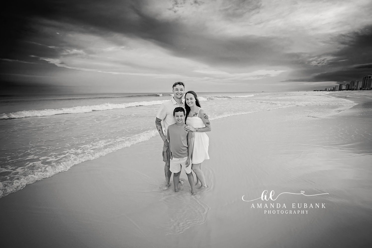 Family Walking in Black and White — Tampa Bay Family Portraits A black and white frame of a family walking together along the shoreline — beach family photography in Tampa Bay.