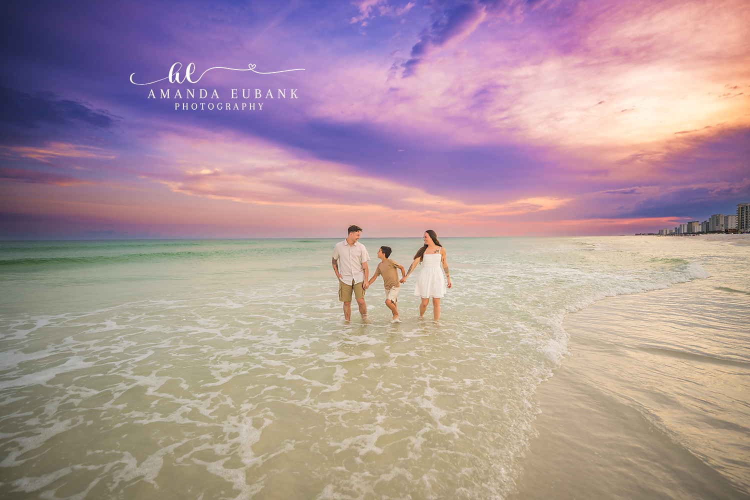 Family Small on a Wide Beach | Tampa Family Photographer A family of three small in the frame on a vast beach under a violet sky during a Tampa family photography session.