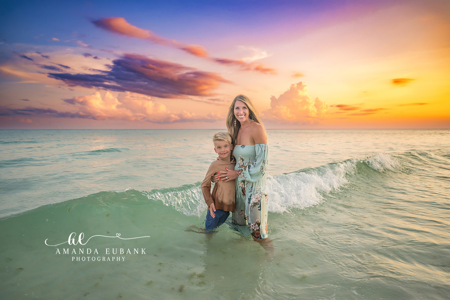 Mother and Son in the Surf — Tampa, FL Family Session A mother and her son standing in the surf as a wave rolls past at sunset at a beach family session near Tampa, Florida.