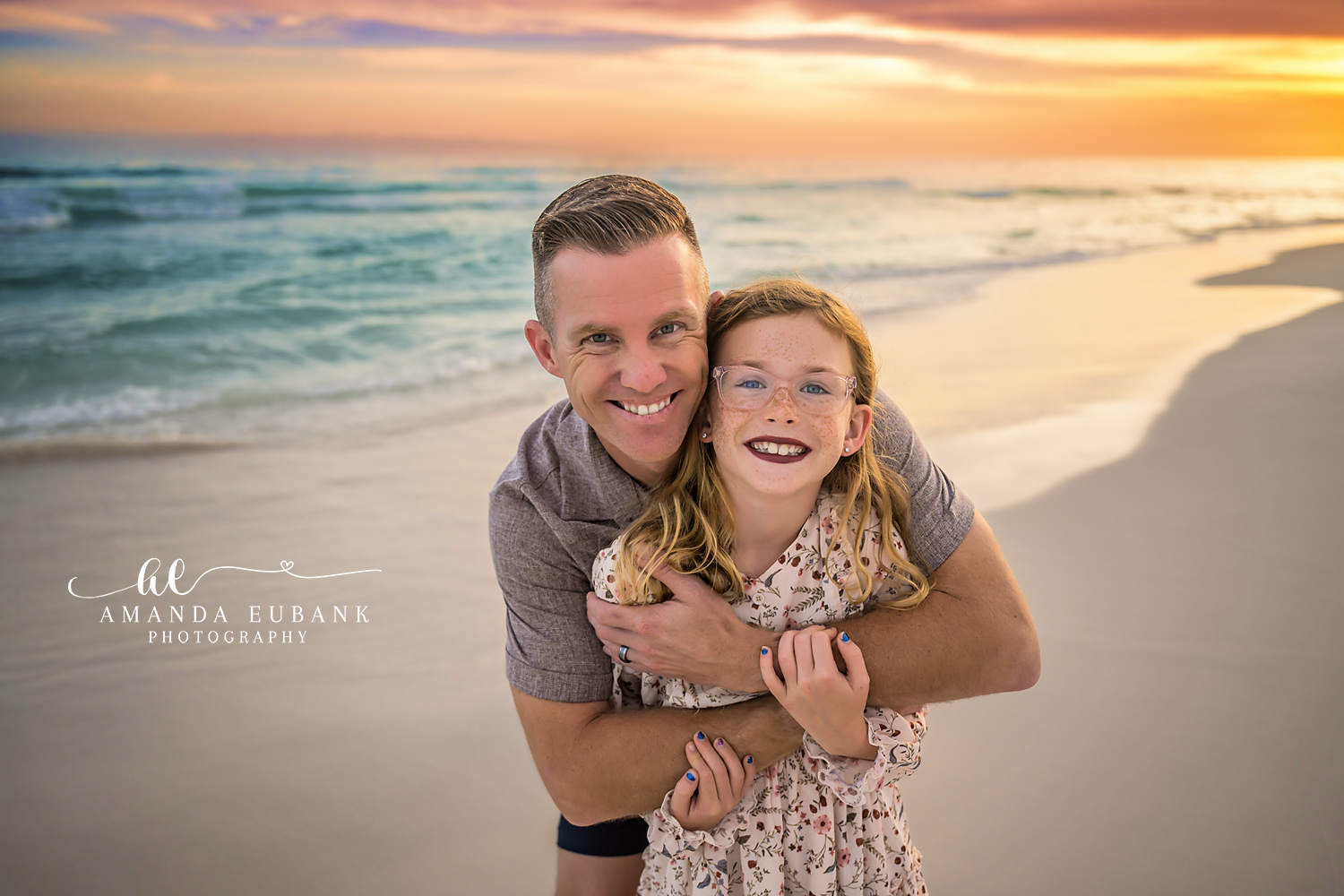 Dad and Daughter Close-Up | Tampa Family Photographer A close portrait of a father hugging his daughter with the sunset behind them during a Tampa family photography session.