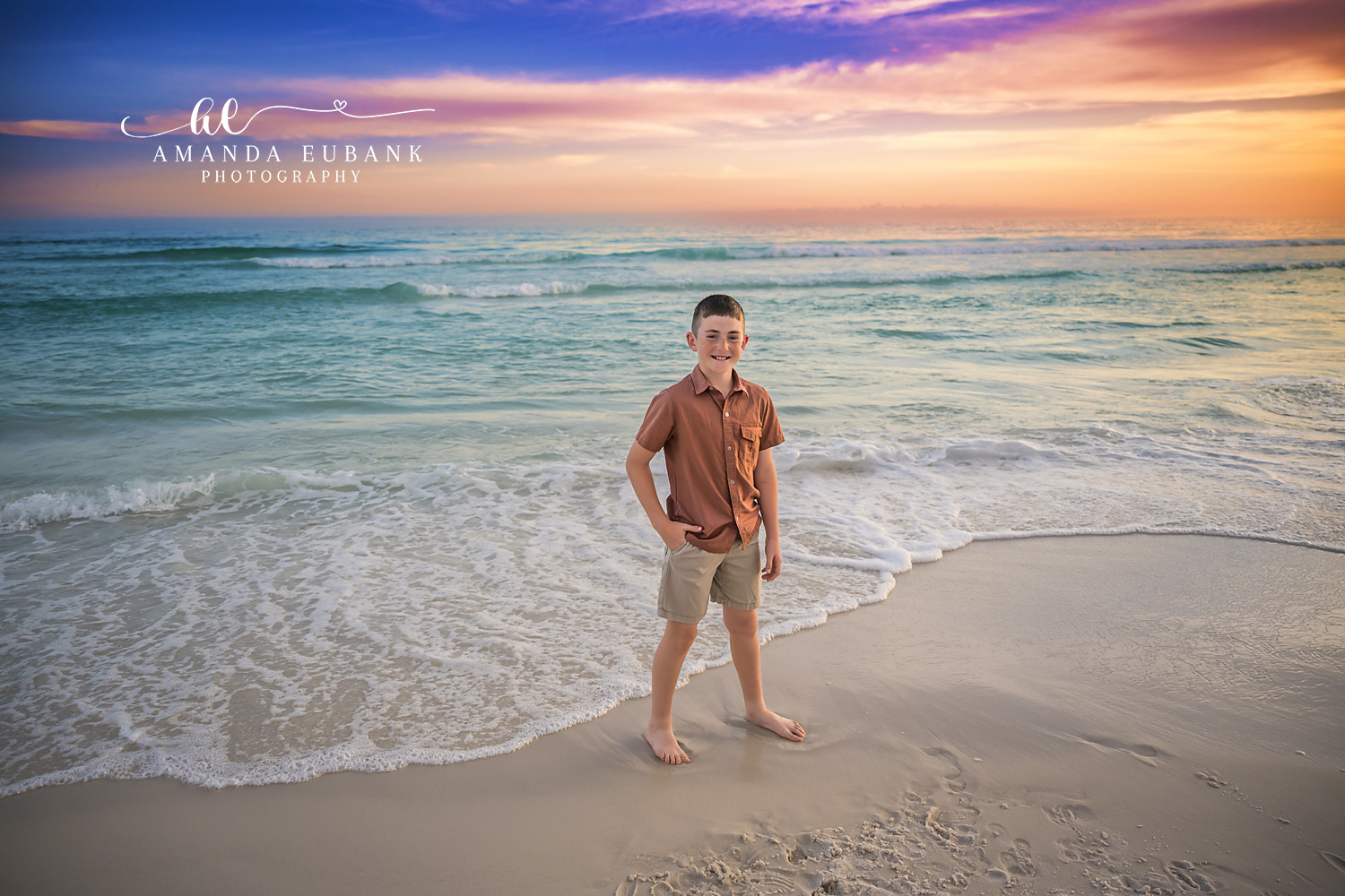 Boy at the Shoreline in Rust — Tampa Bay Children’s Photography A young boy in rust standing at the shoreline as the sun sets over the Gulf at a beach kids session in Tampa, FL.