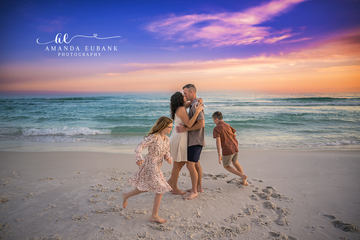 Kids Circling Their Parents — Tampa, FL Family Session Two children running around their parents on the beach at pastel sunset at a beach family session near Tampa, Florida.