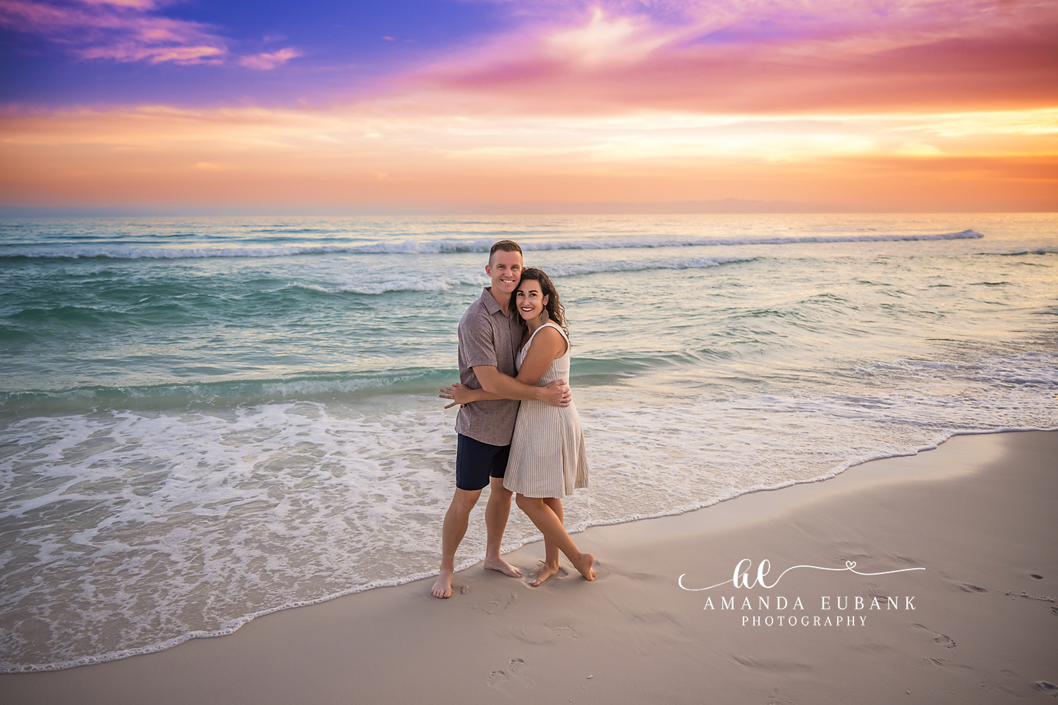 Couple Embracing in the Shallows | Tampa Beach Couples Photography Tampa couples photographer captures a couple holding each other in the shallow surf as the sun sinks low.