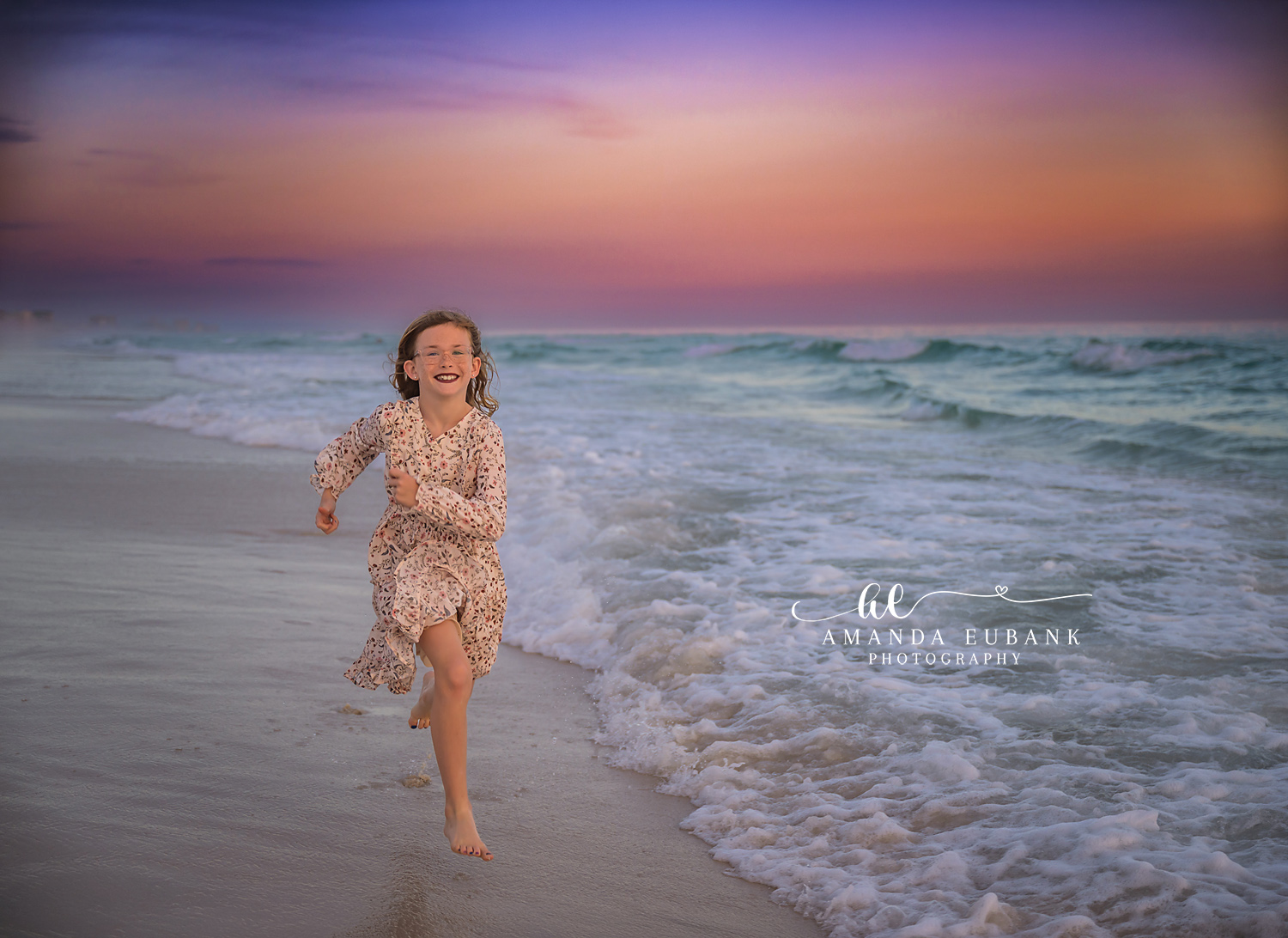 Girl Running Through the Surf | Tampa Children’s Photographer A girl in a floral dress running through the shallow surf at dusk during a children’s portrait session in Tampa, Florida.