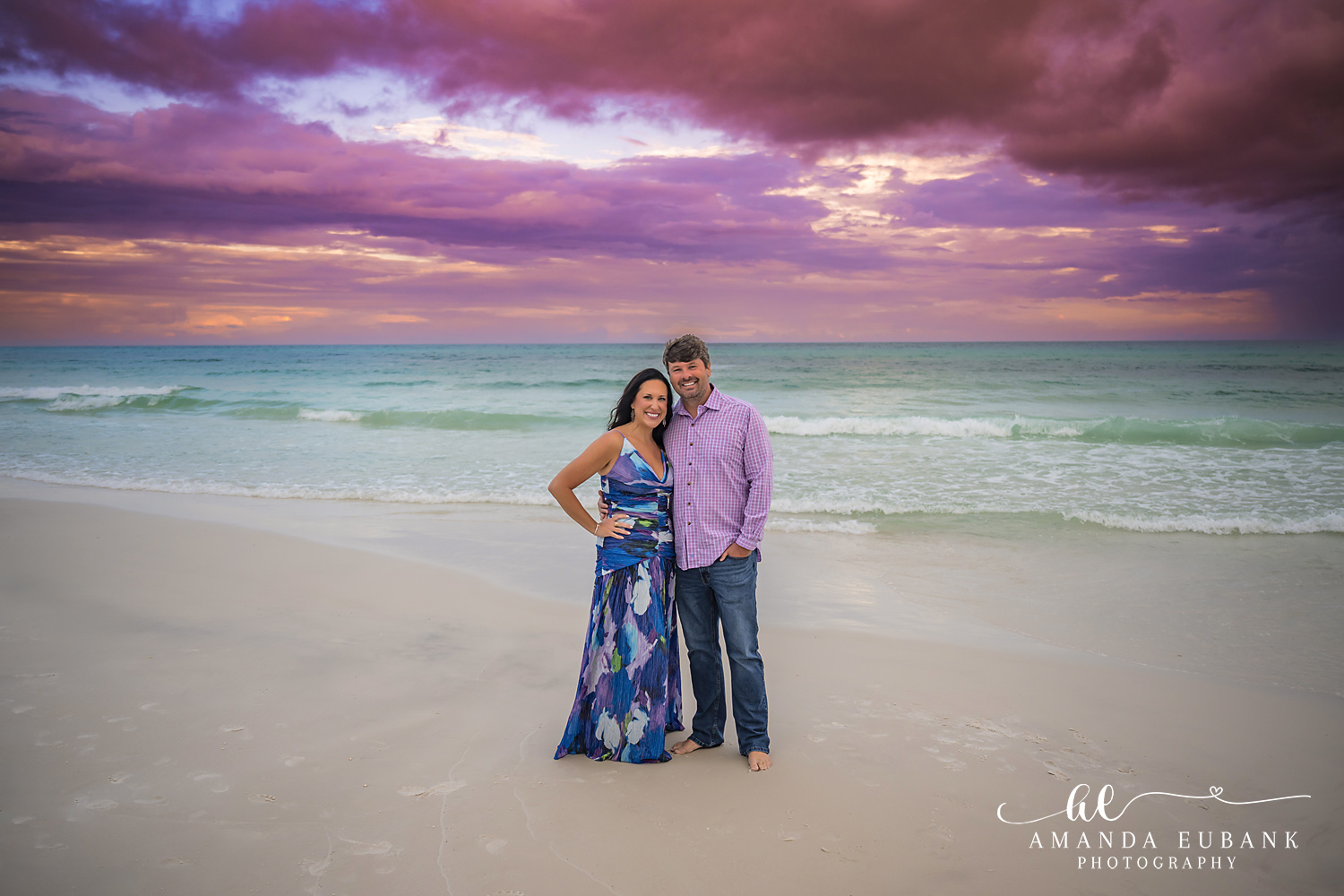Parents in Navy and Pink | Couples Photographer in Tampa, Florida Couples portraits in Tampa, FL showing a couple standing arm in arm on the sand in navy and pink at dusk.