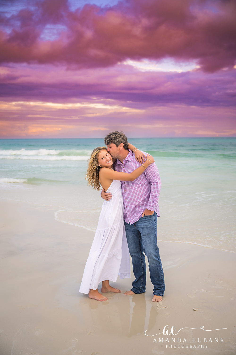 Couple Laughing at the Shore | Couples Photographer in Tampa, Florida Couples portraits in Tampa, FL showing a couple laughing together at the shoreline in pink and white at dusk.