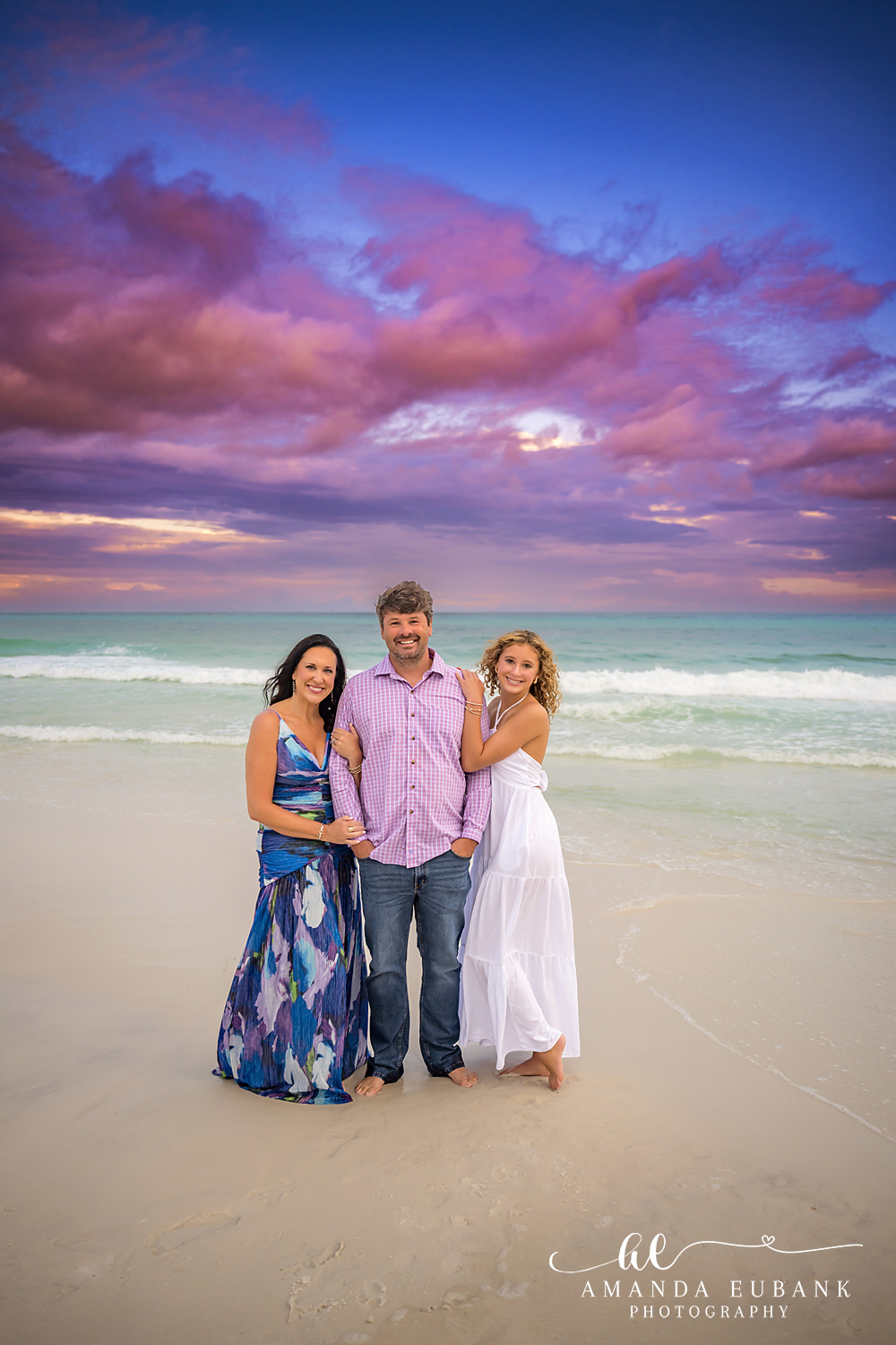 Mother and Daughters on the Sand | Tampa Beach Family Photography Tampa family photographer captures a mother and her two daughters standing together on the beach at dusk.