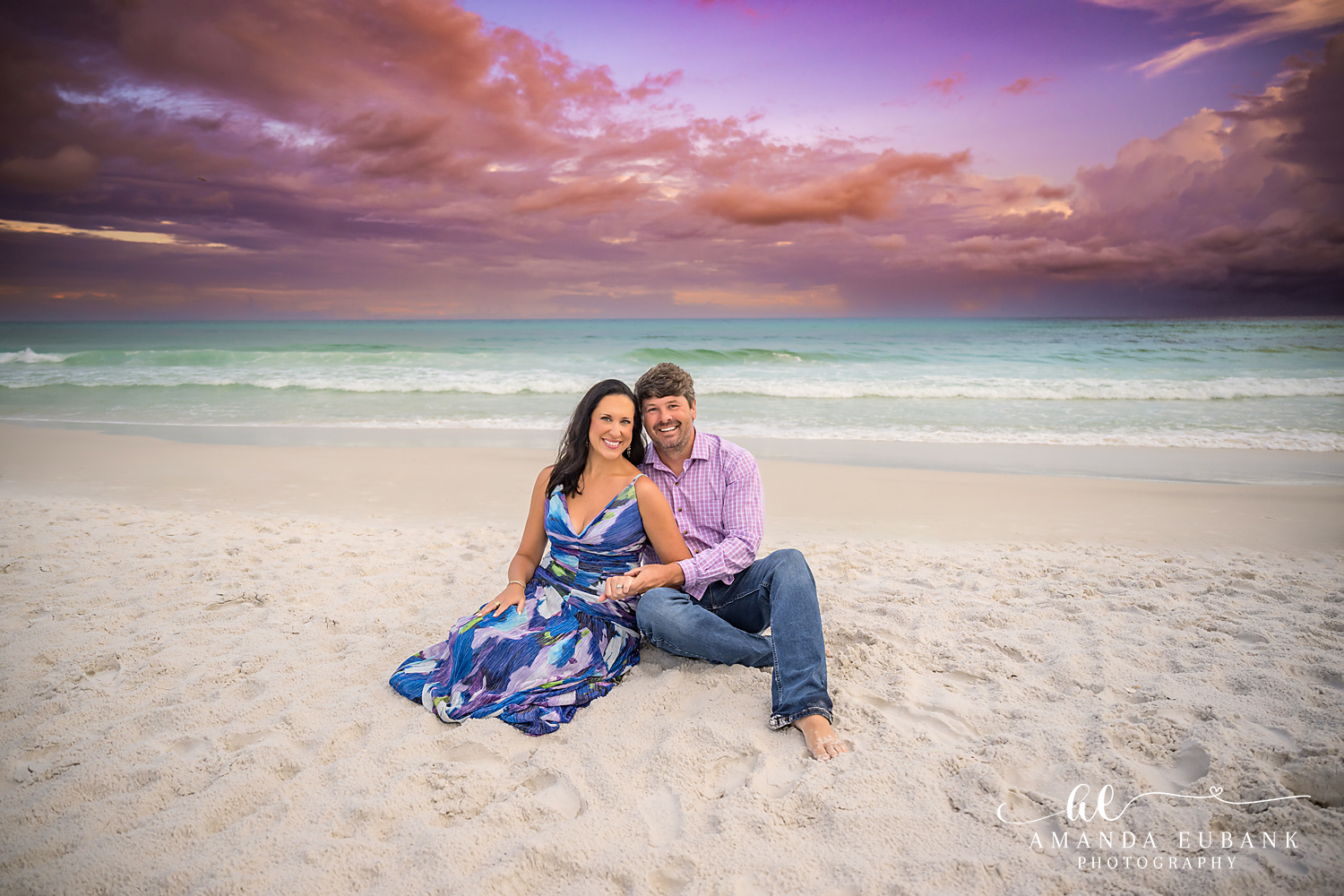 Family Sitting on the Sand at Dusk — Tampa, FL Family Session A family of four sitting together on the sand in blue and white at dusk at a beach family session near Tampa, Florida.