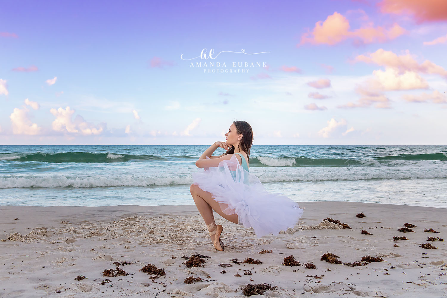 Senior in White by the Gulf | Senior Portraits in Tampa, FL Tampa senior photographer captures a senior in a white dress seated on the sand beside the turquoise Gulf.