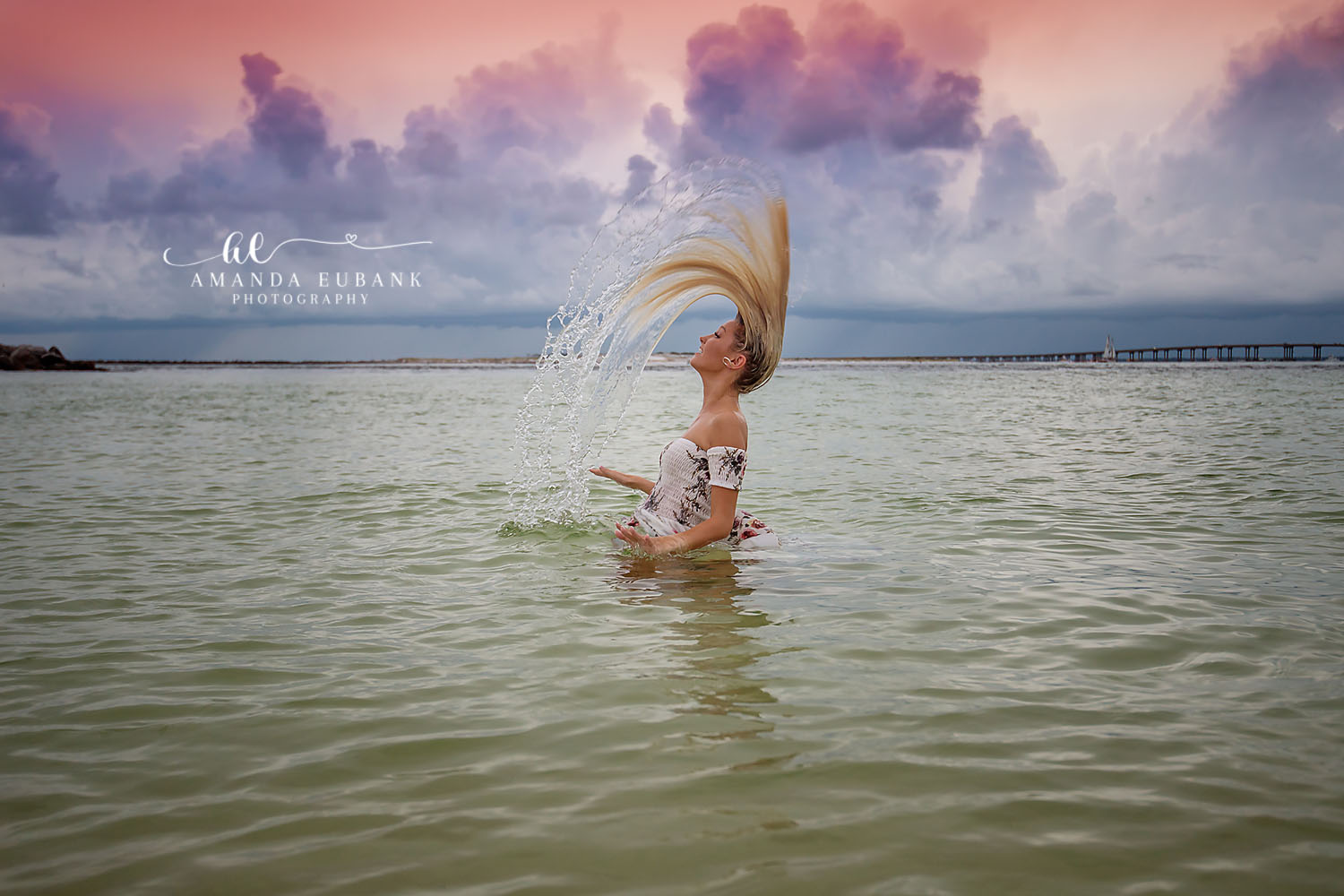 Hair Flip in the Gulf | Beach Senior Session in Tampa, Florida Senior pictures in Tampa Bay showing a senior flipping her wet hair in the Gulf as water arcs behind her.