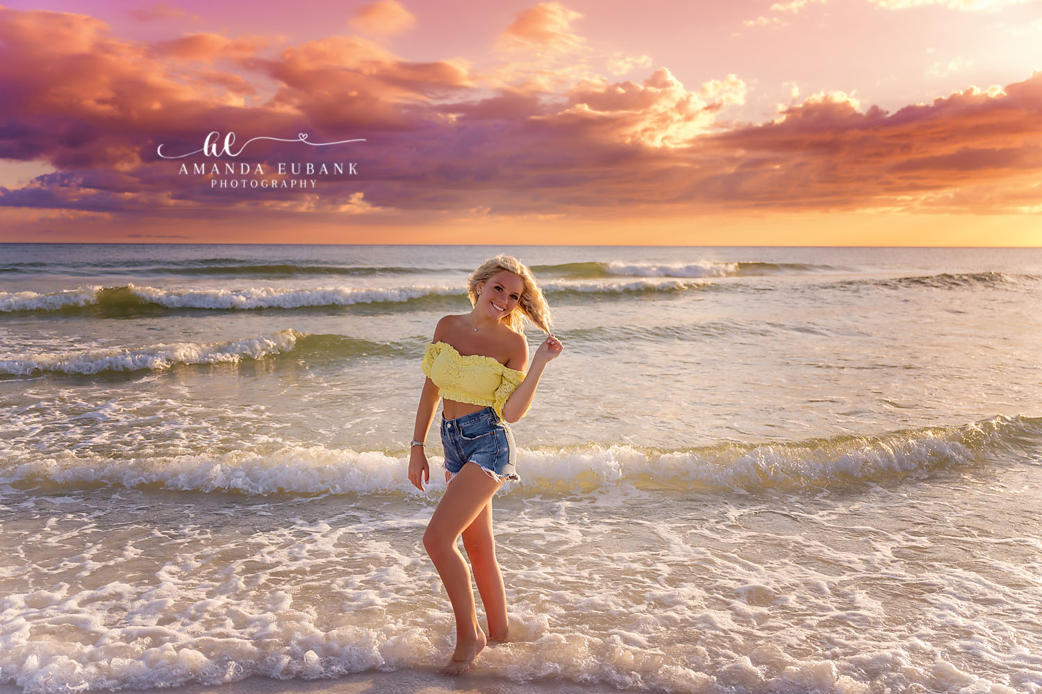 Yellow Top and Denim | Senior Portraits in Tampa, FL Tampa senior photographer captures a senior in a yellow top and denim shorts standing in the shallows at sunset.