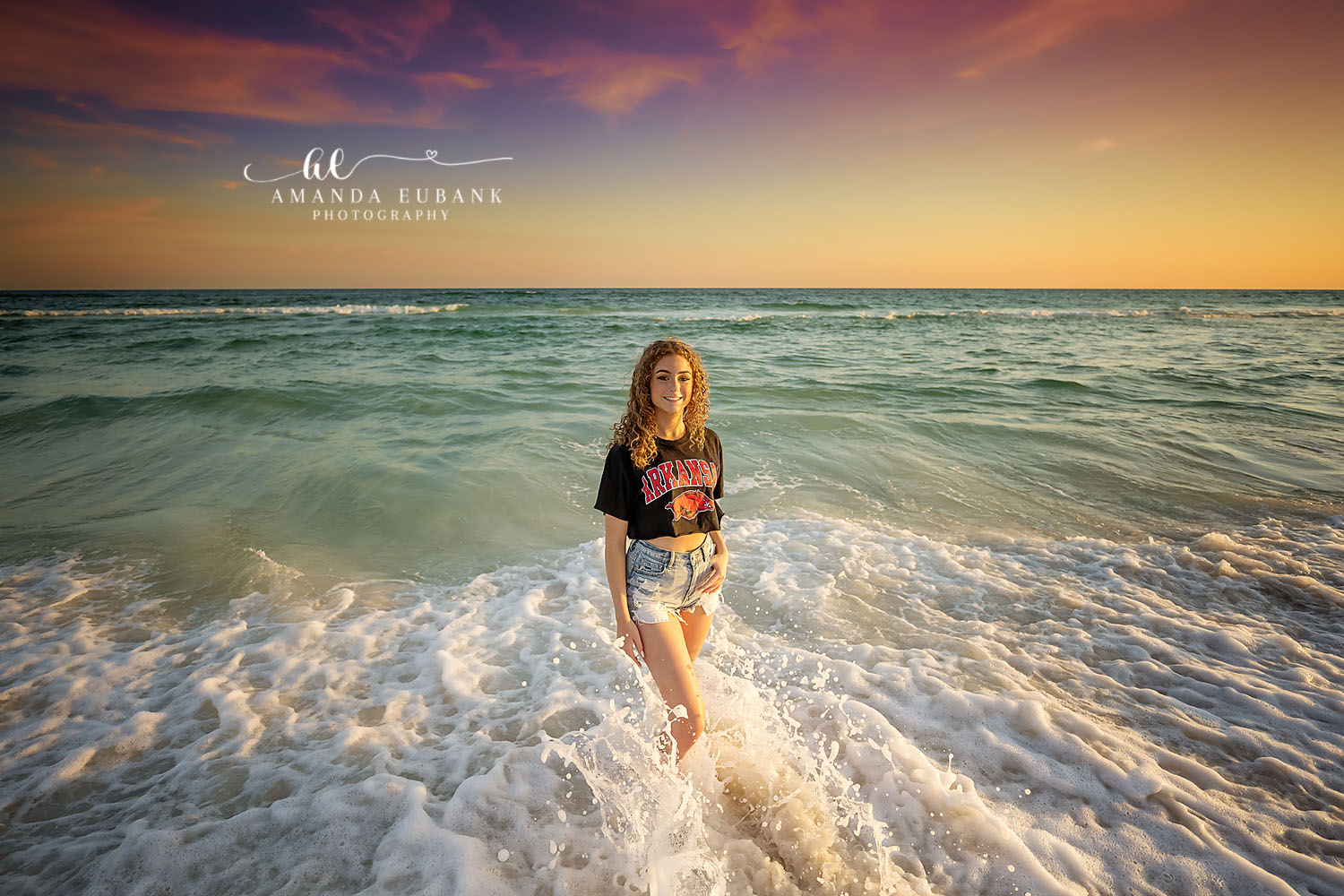 Standing in the Breaking Waves | Senior Portraits in Tampa, FL Tampa senior photographer captures a senior standing in churning surf as the Gulf turns emerald at sunset.