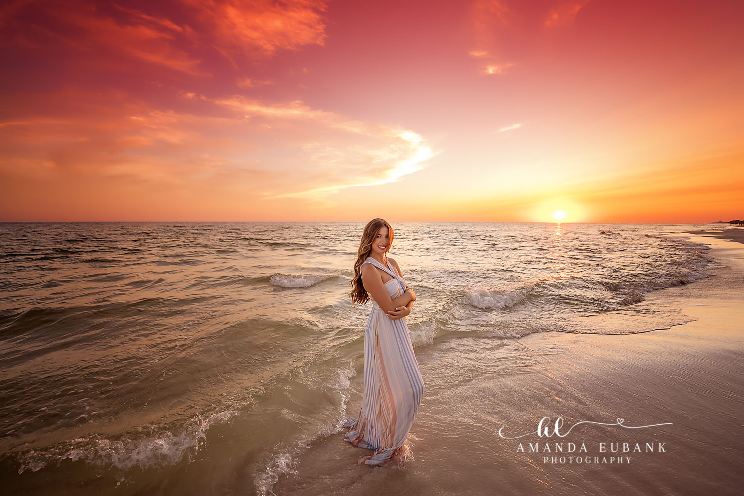 Expecting at Sunset | Tampa Beach Maternity Photography Tampa maternity photographer captures an expectant mother in a white gown standing in the surf as the sun sets.