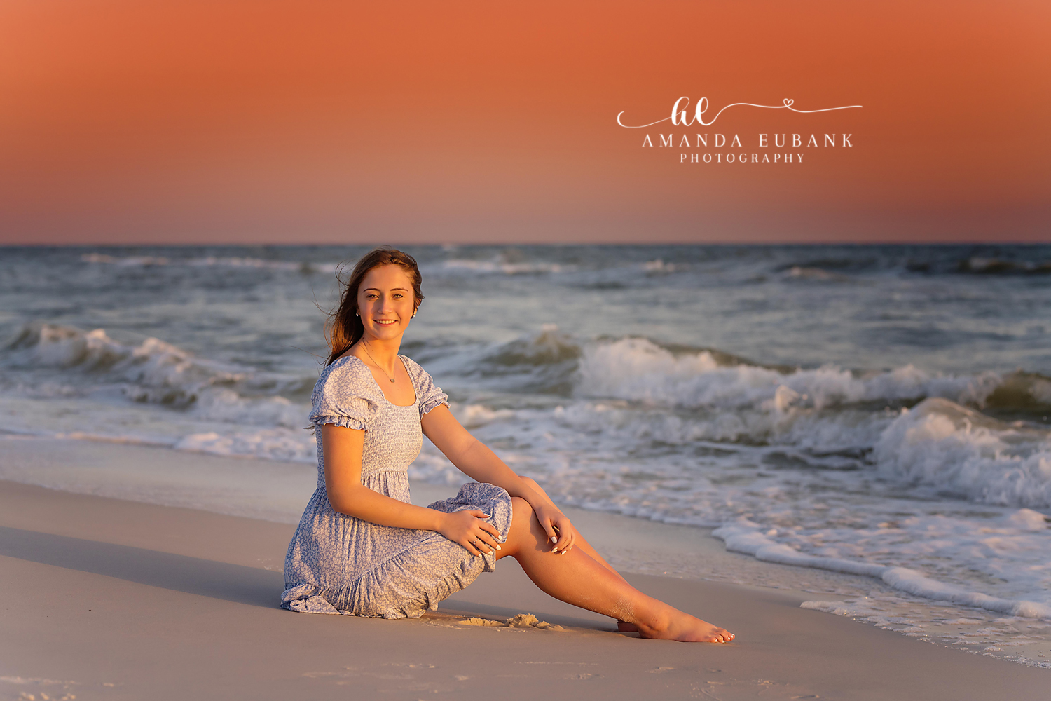 Senior Seated by the Surf | Senior Portraits in Tampa, FL Tampa senior photographer captures a senior in a light dress seated on the sand beside the breaking surf at dusk.