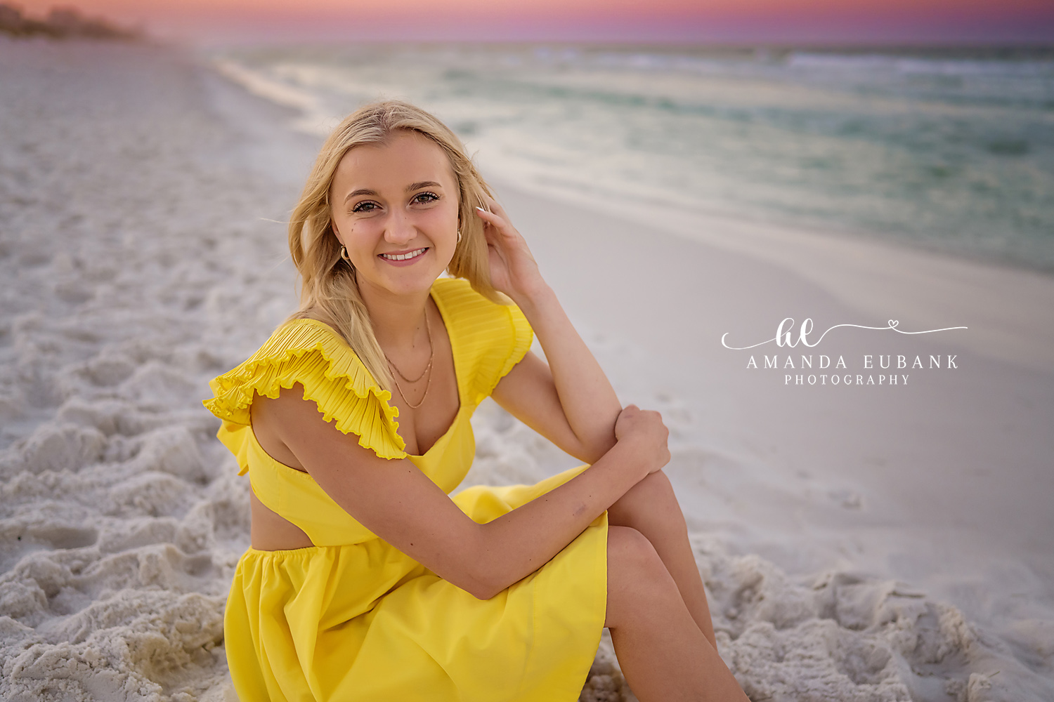 Yellow Dress Close-Up | Beach Senior Session in Tampa, Florida Senior pictures in Tampa Bay showing a close portrait of a senior in a yellow dress seated on white sand.