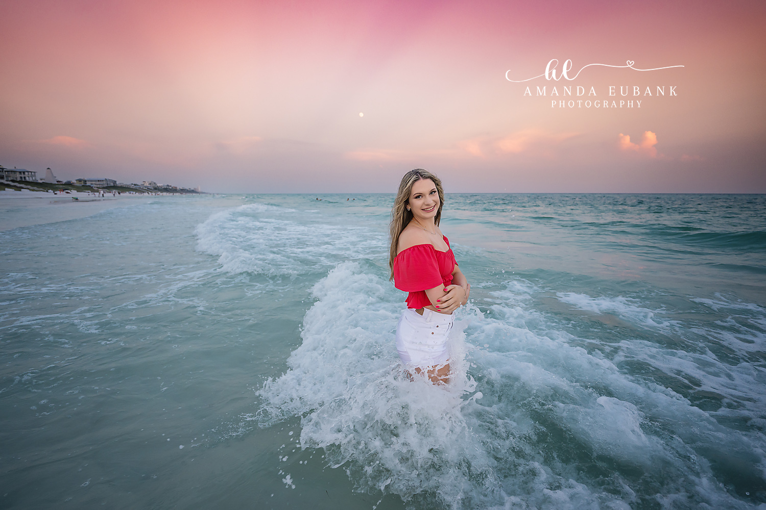 Red Top in the Breaking Surf | Tampa Senior Photographer A senior in a red top and white skirt standing in the churning surf during a senior portrait session in Tampa, Florida.