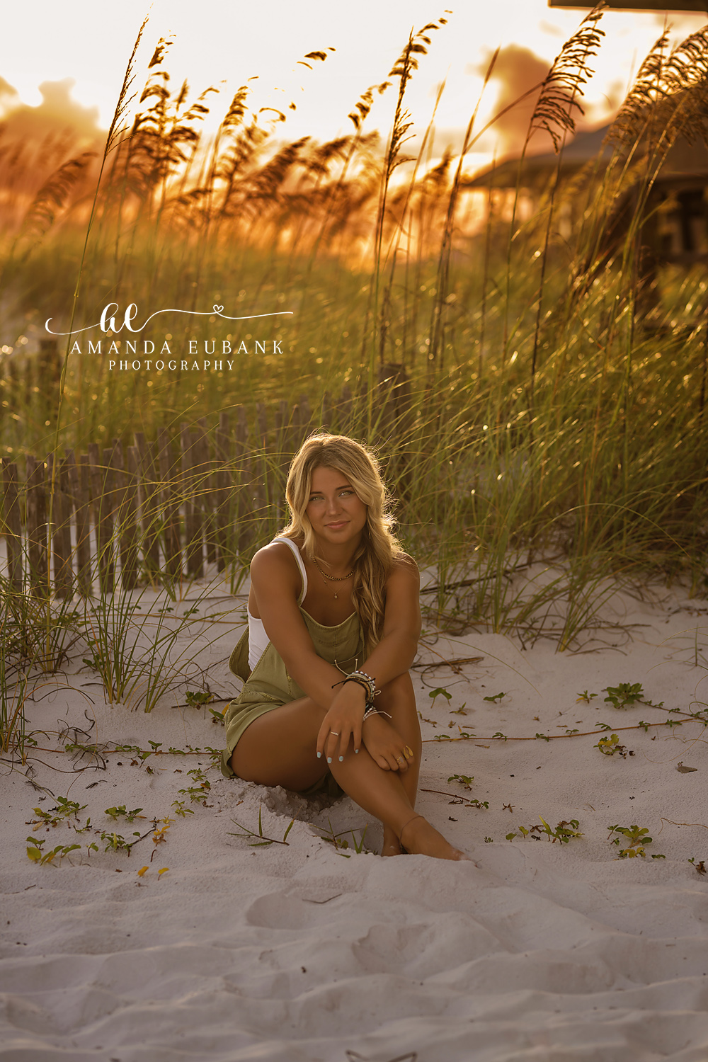 Golden Sea Oats Portrait — Tampa Bay Senior Photography A senior seated in the dunes as low sun lights the sea oats behind her at a beach senior session in Tampa, FL.