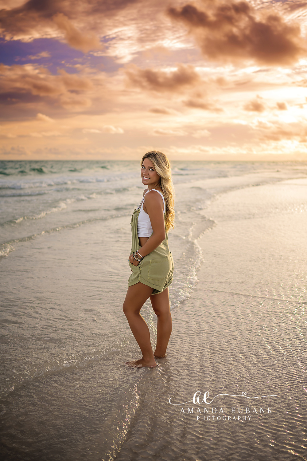Standing on Wet Sand at Dusk | Tampa Senior Photographer A senior in a green dress standing on the wet sand as the sky glows gold during a senior portrait session in Tampa, Florida.