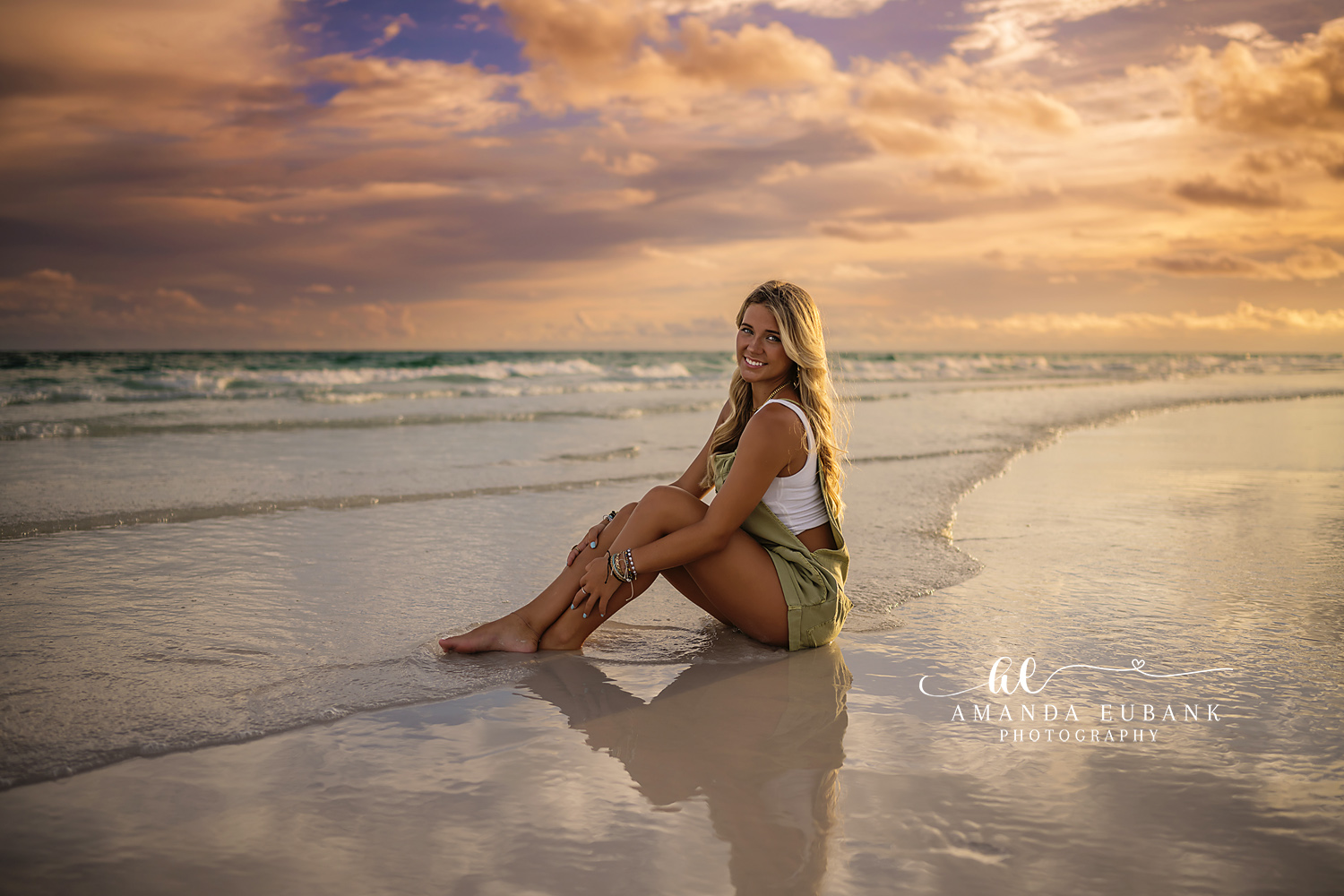 Green Dress on the Shoreline | Senior Portraits in Tampa, FL Tampa senior photographer captures a senior in a green dress seated on the shoreline with light on the water.
