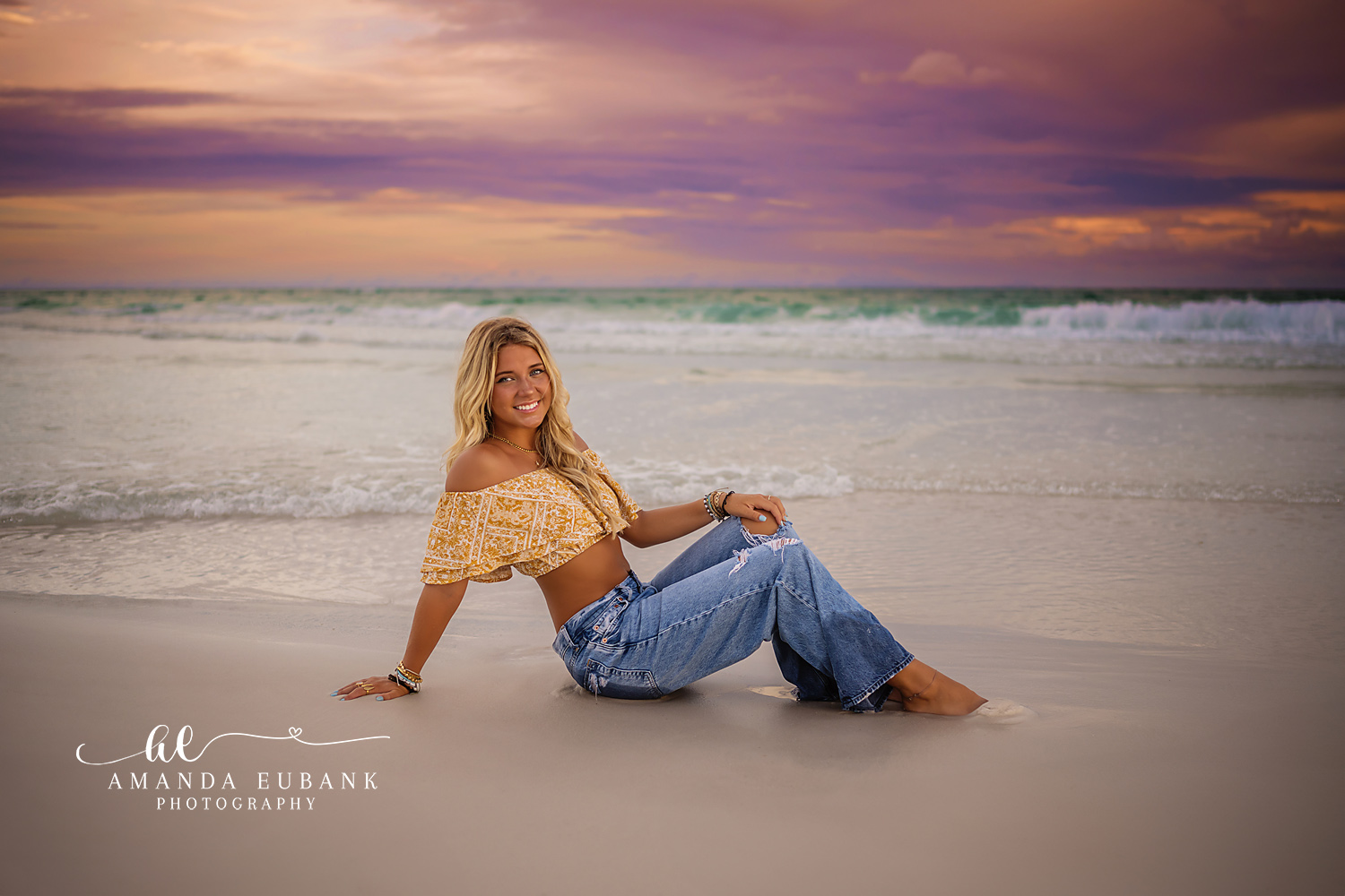 Seated on the Reflective Shore | Tampa Senior Photographer A senior in yellow and denim seated on the wet sand at violet sunset during a senior portrait session in Tampa, Florida.