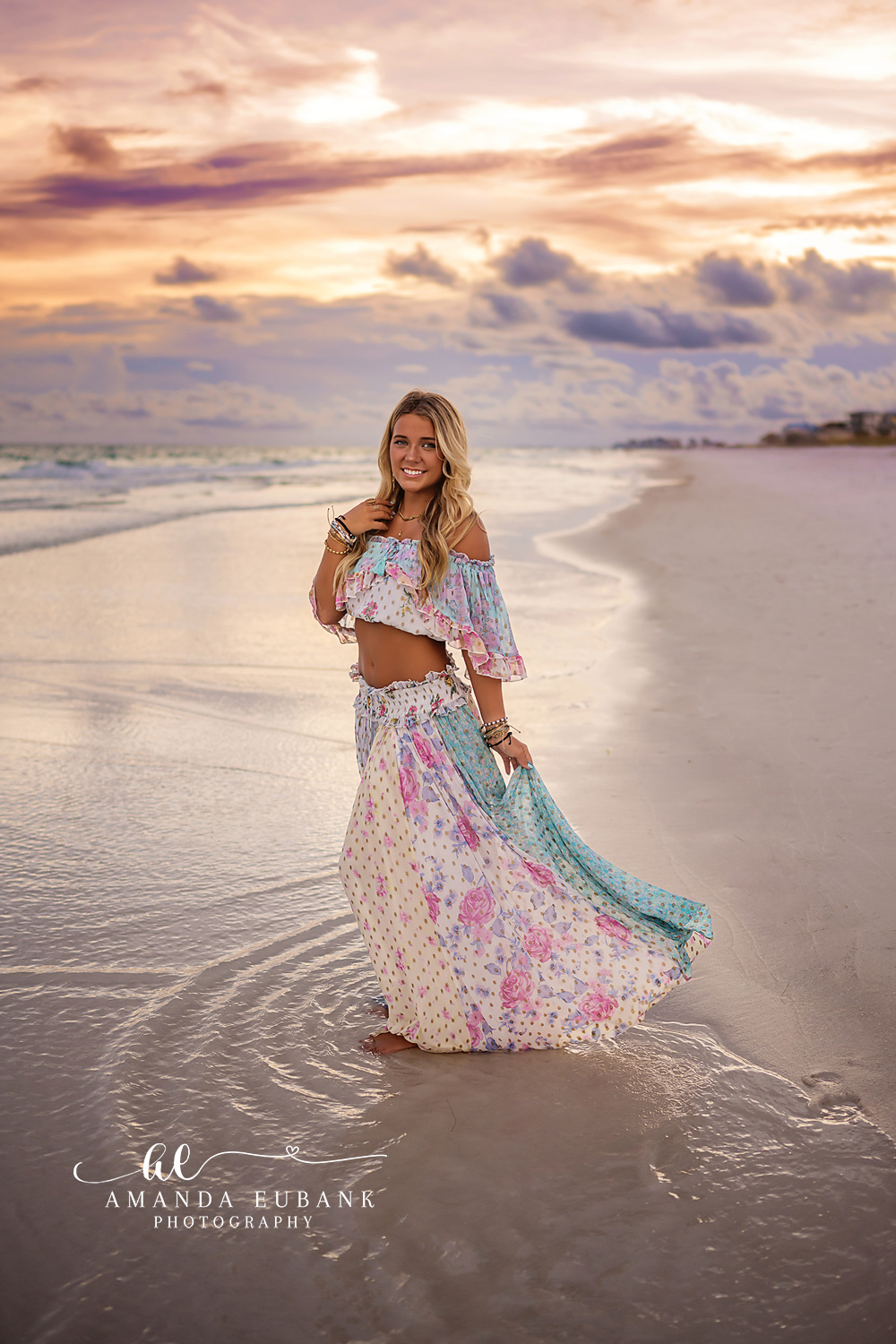 Floral Skirt in the Shallows | Tampa Senior Photographer A senior in a floral maxi skirt standing in the shallow surf at dusk during a senior portrait session in Tampa, Florida.
