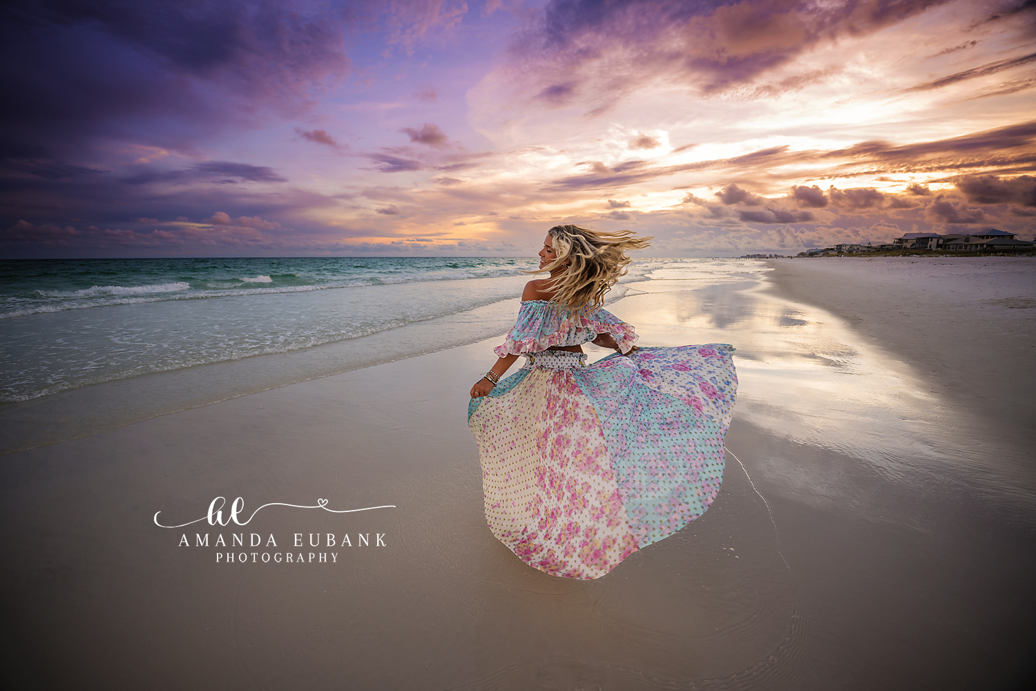 Skirt Spread on the Wet Sand | Beach Senior Session in Tampa, Florida Senior pictures in Tampa Bay showing a senior seated with her floral skirt spread across mirror-wet sand.