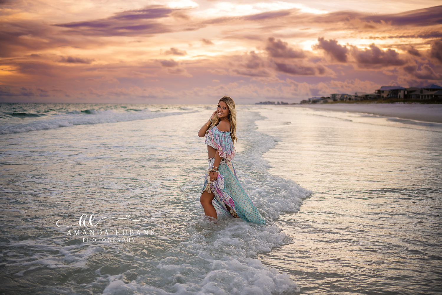 Standing in the Emerald Surf | Tampa Senior Photographer A senior in a floral maxi dress standing in the emerald surf at golden hour during a senior portrait session in Tampa, Florida.