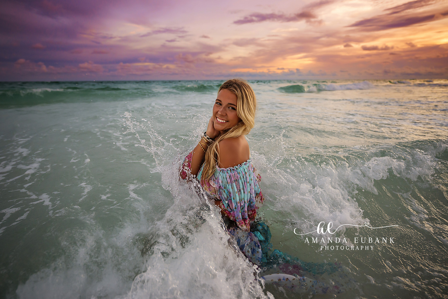 Surf Break Senior Portrait — Tampa Bay Senior Photography A senior in a floral dress on the shoreline with surf churning behind her at a beach senior session in Tampa, FL.