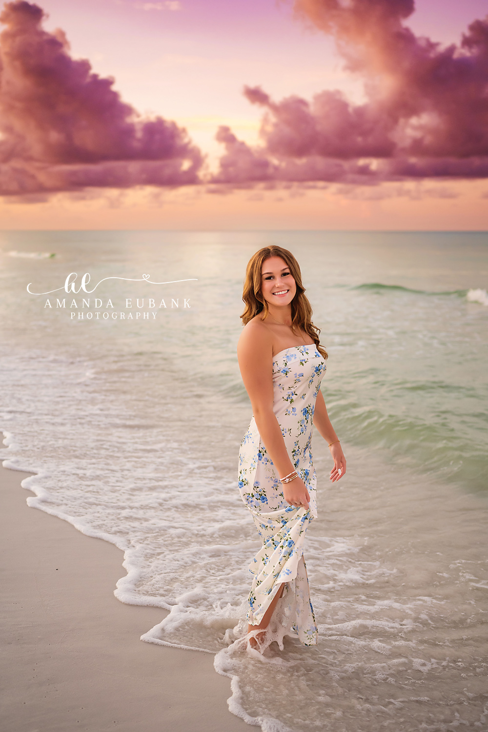Walking Through the Shallows | Senior Portraits in Tampa, FL Tampa senior photographer captures a senior in a floral dress walking through the shallow surf at sunset.