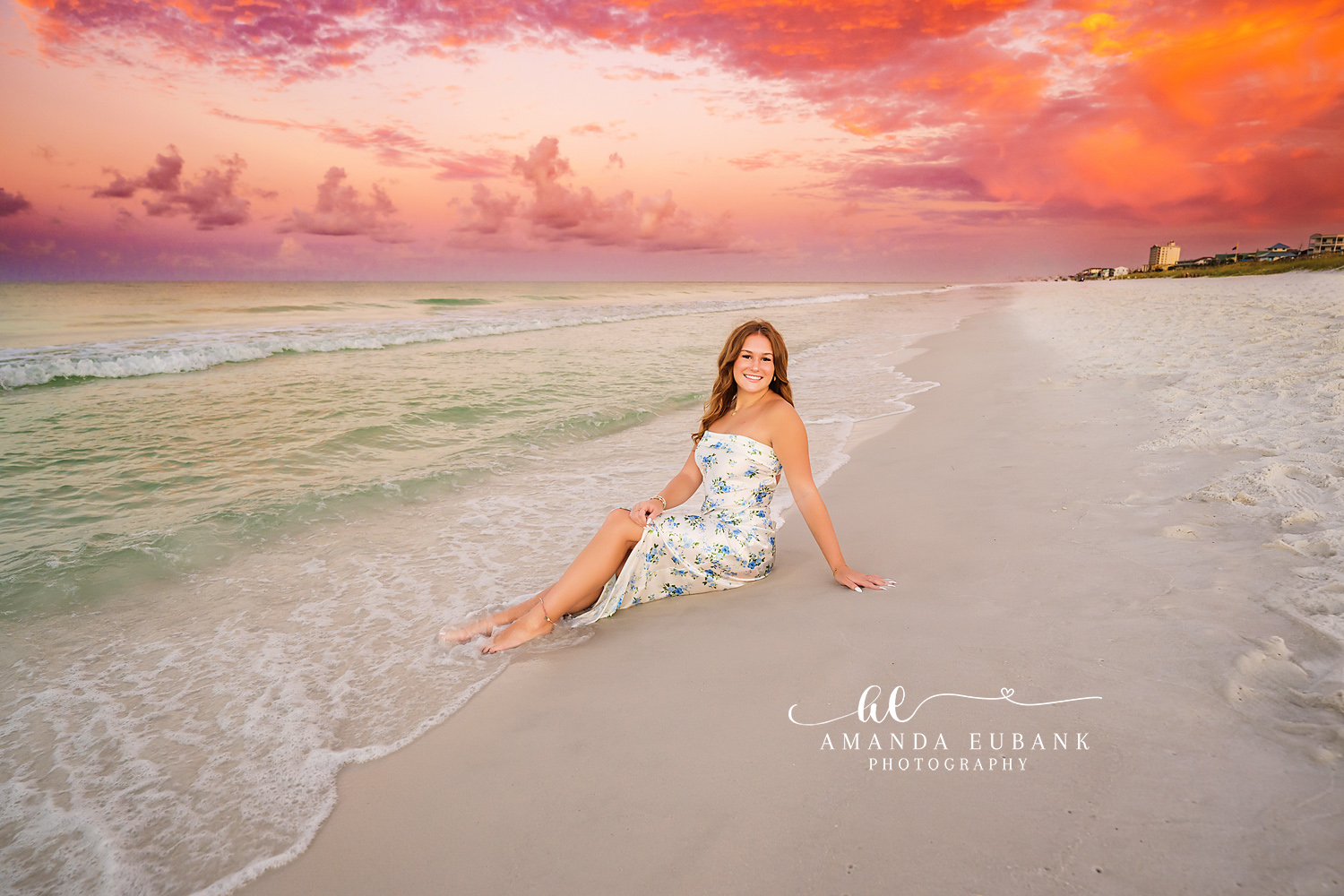 Wave at Her Feet | Senior Portraits in Tampa, FL Tampa senior photographer captures a senior in a floral dress on the wet sand as a wave slides toward her.