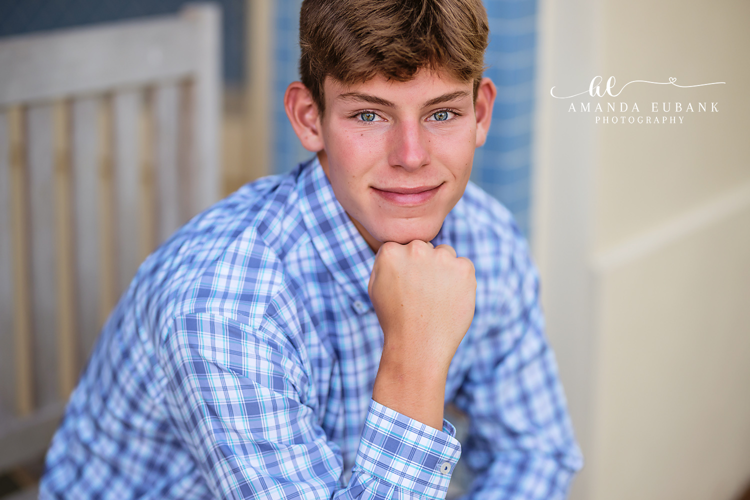 Senior Guy Portrait | Tampa Senior Photographer for Guys A portrait of a senior guy in a blue plaid shirt leaning against a railing during a senior session in Tampa, Florida.