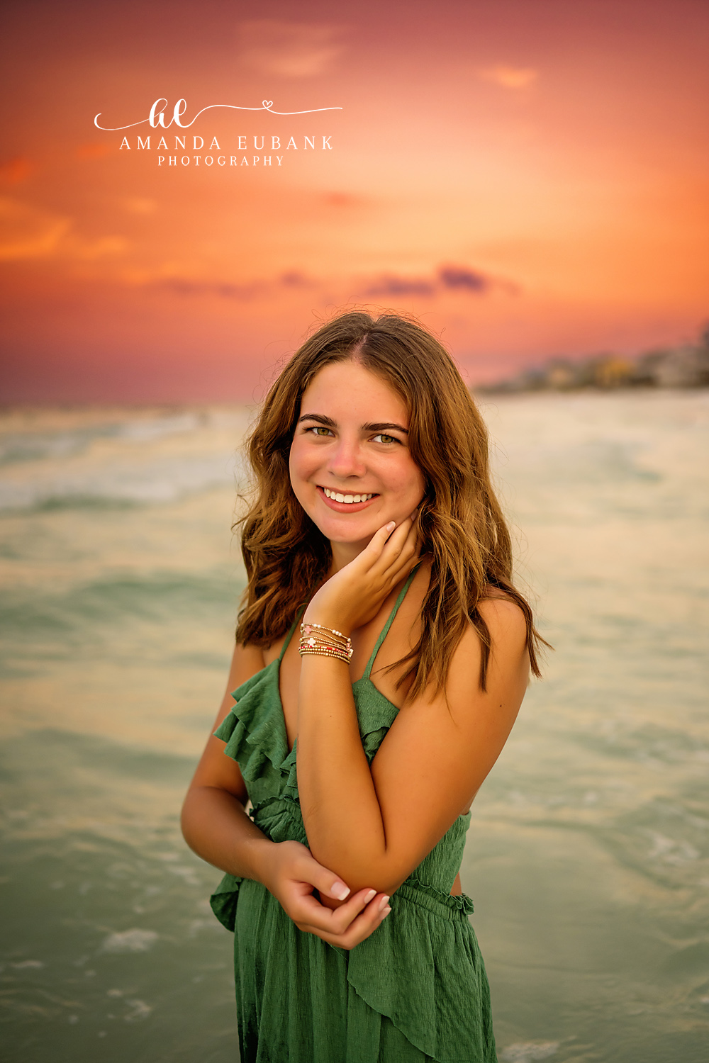 Green Gown Close Portrait — Tampa Bay Senior Photography A close portrait of a senior in a green gown with an orange sky behind her at a beach senior session in Tampa, FL.