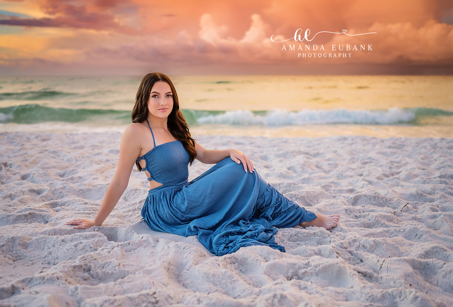 Blue Gown Spread on the Sand | Tampa Senior Photographer A senior in a blue gown seated with the fabric spread across white sand during a senior portrait session in Tampa, Florida.