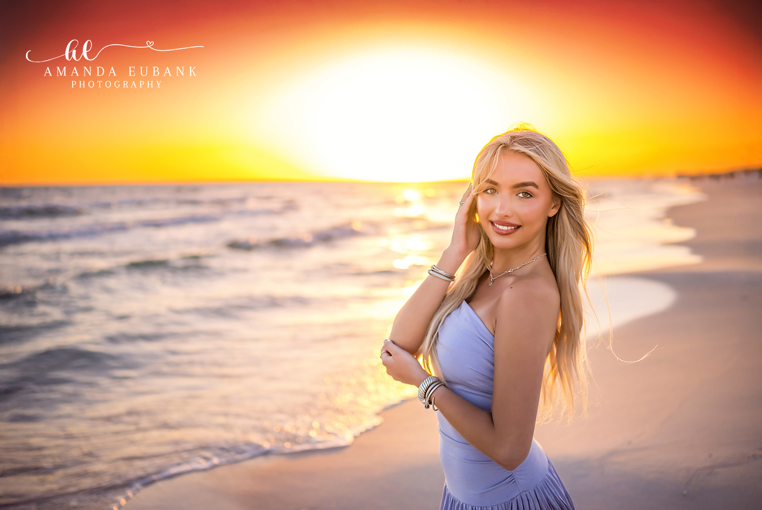 Backlit by the Setting Sun | Beach Senior Session in Tampa, Florida Senior pictures in Tampa Bay showing a senior in a lavender dress on the shoreline backlit by the setting sun.