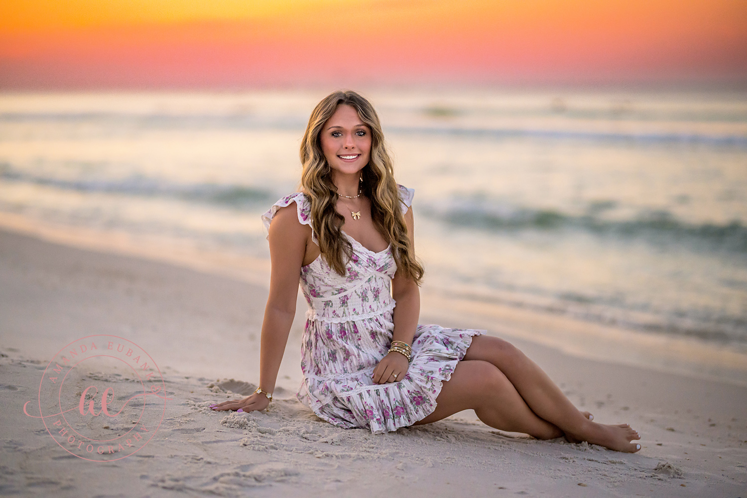 White Lace on the Sand | Tampa Senior Photographer A senior in a white lace dress seated on the sand in soft pastel light during a senior portrait session in Tampa, Florida.