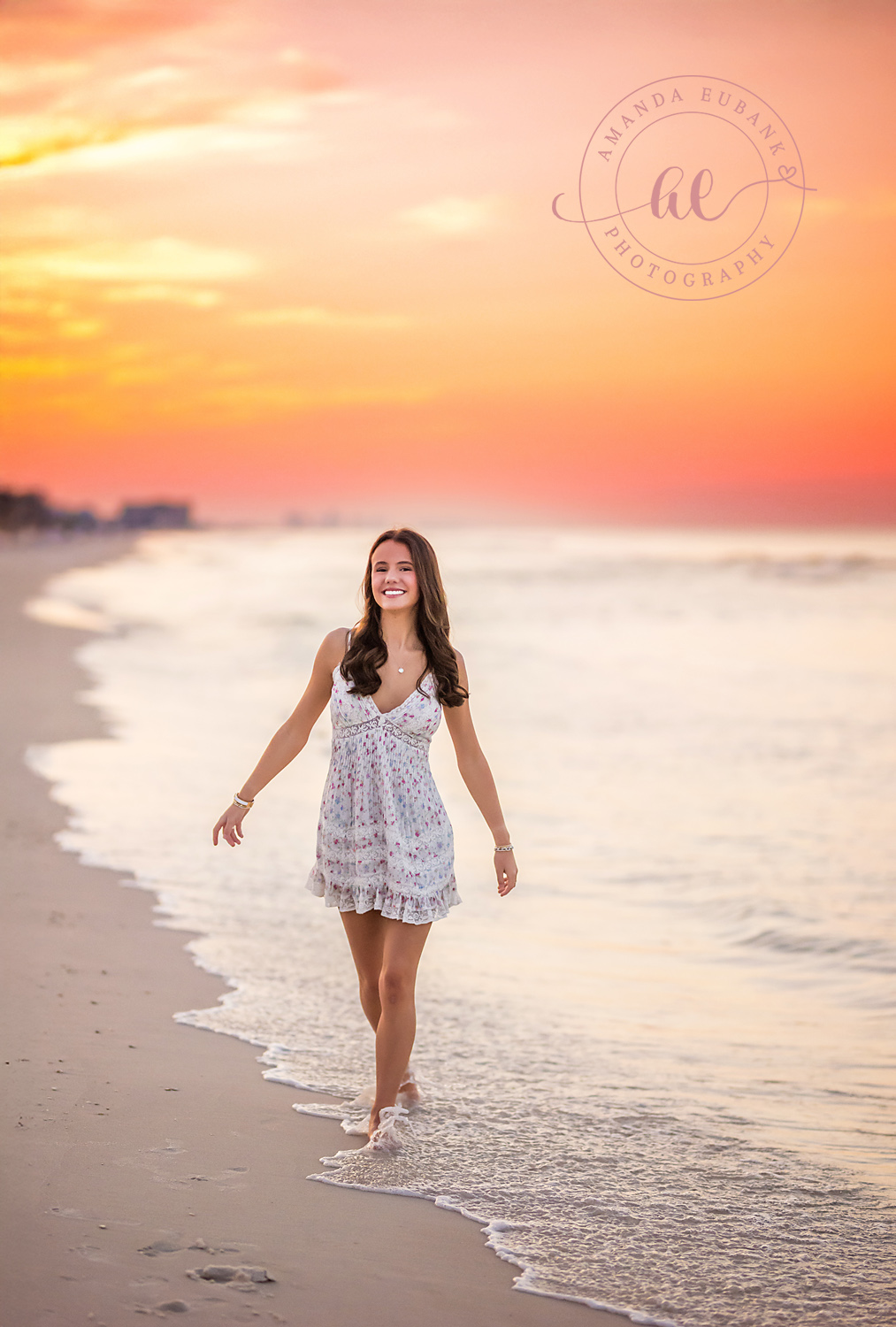 Lace Dress at Sunset — Tampa Bay Senior Photography A senior in a white lace dress walking the wet sand as the sky glows coral at a beach senior session in Tampa, FL.