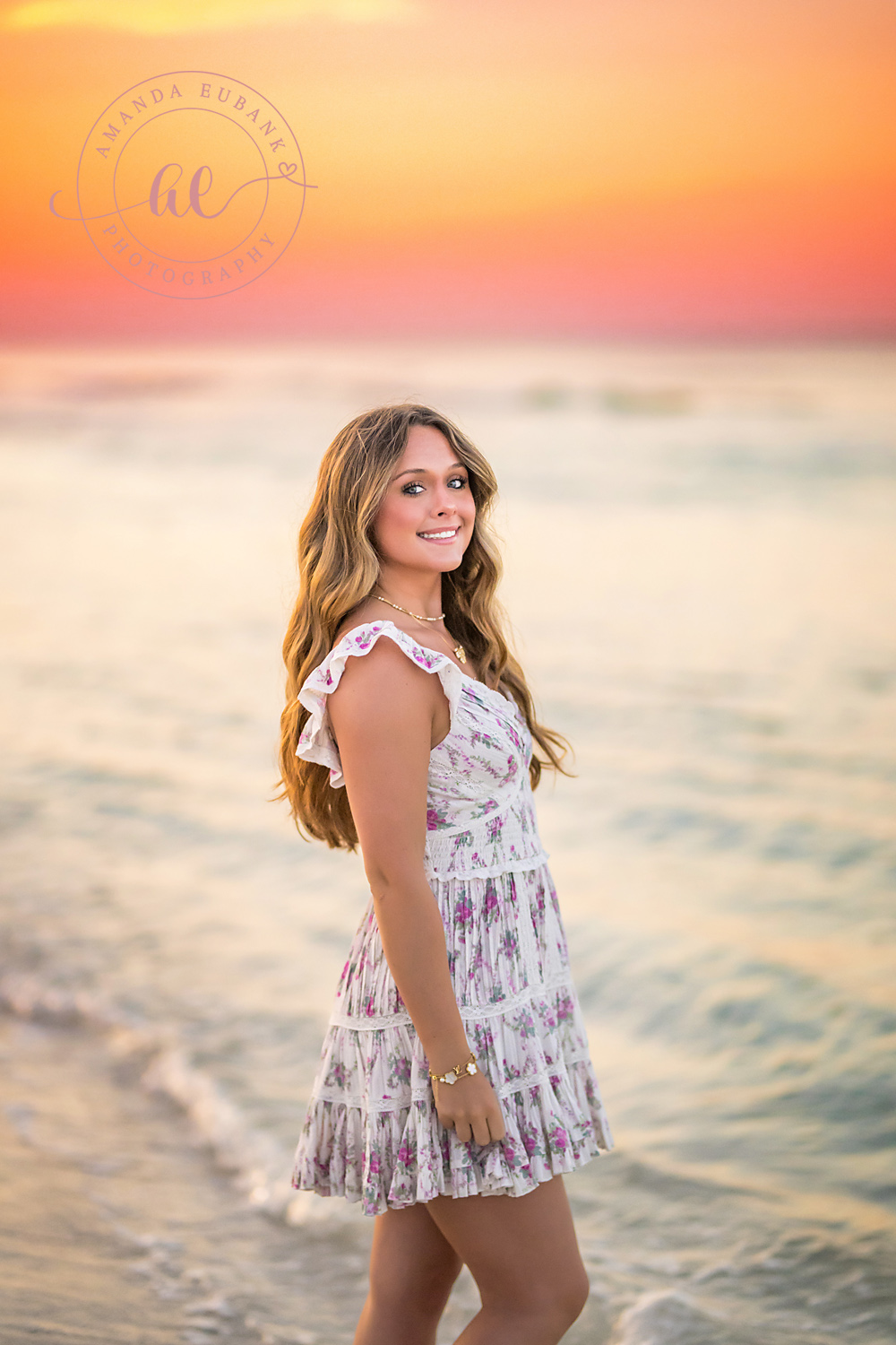 Standing in White Lace | Beach Senior Session in Tampa, Florida Senior pictures in Tampa Bay showing a senior in a white lace dress standing on the sand at pastel golden hour.