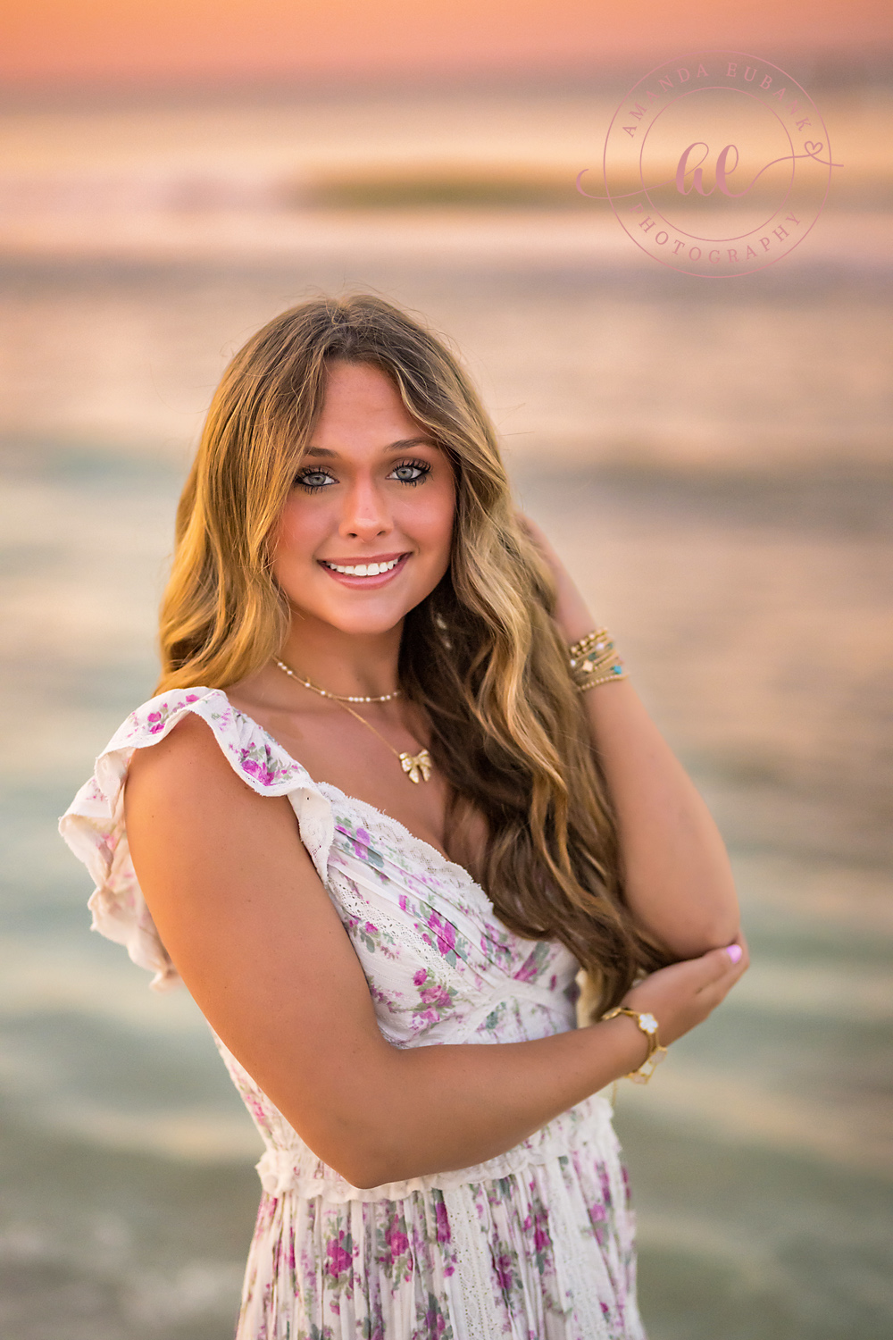 Close-Up in a Floral Dress | Tampa Senior Photographer A close portrait of a smiling senior in a white floral dress by the Gulf during a senior portrait session in Tampa, Florida.