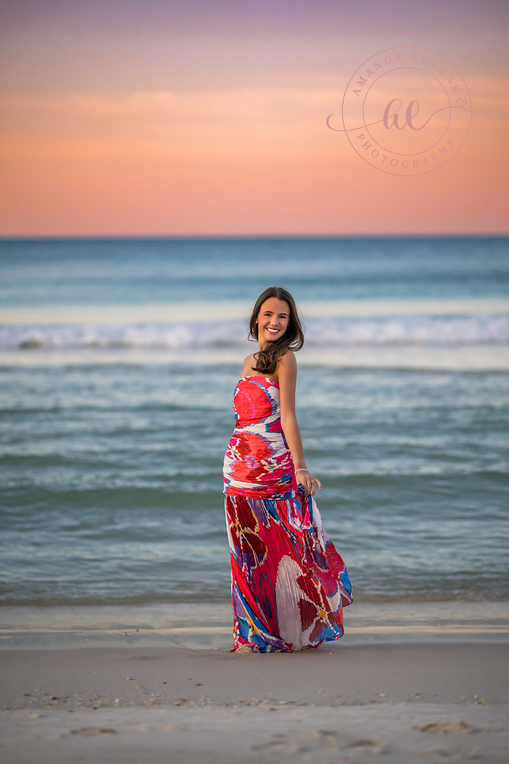 Pink Gown by the Emerald Gulf | Tampa Senior Photographer A senior in a pink gown standing on the wet sand beside the emerald Gulf during a senior portrait session in Tampa, Florida.