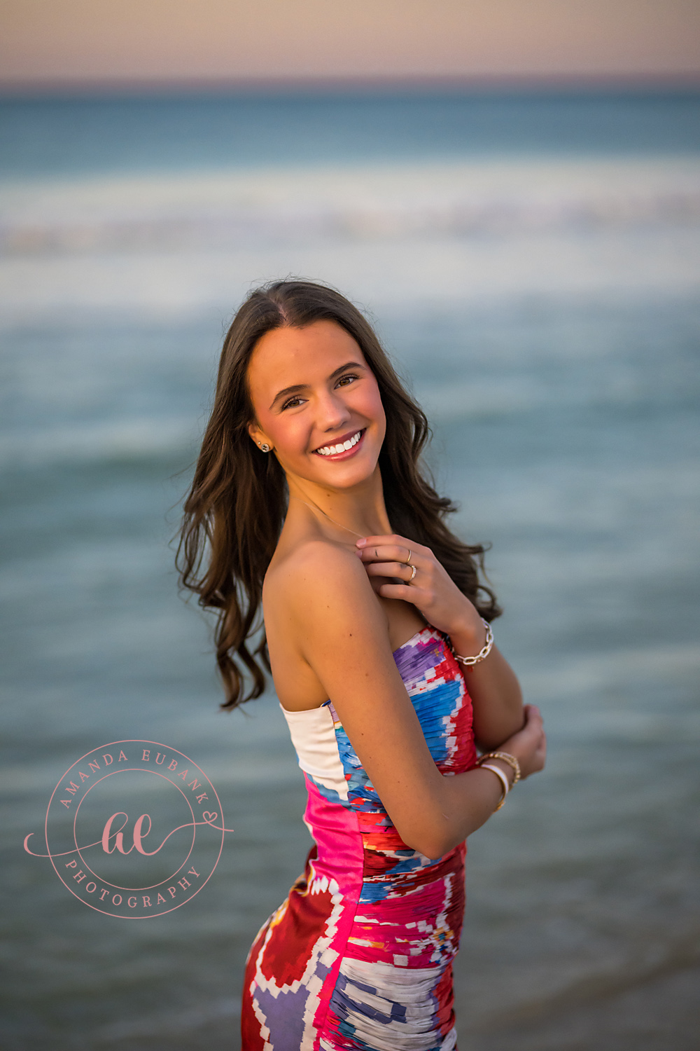 Laughing Close-Up Portrait | Senior Portraits in Tampa, FL Tampa senior photographer captures a close portrait of a laughing senior in a pink gown with the Gulf behind.