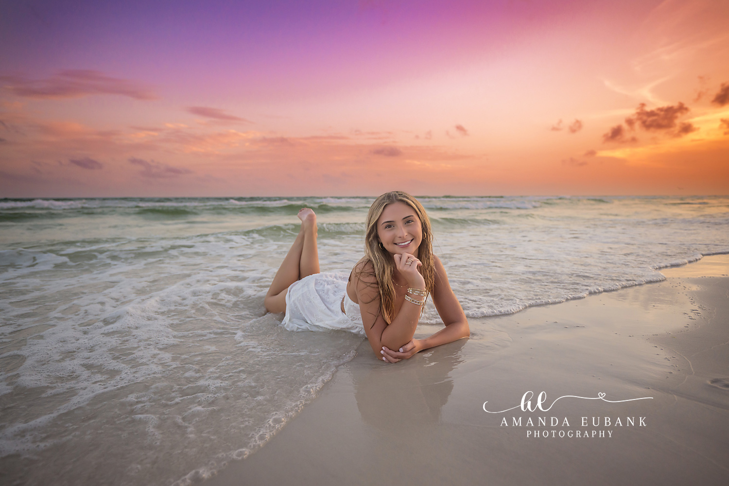 Sunset Behind the Shoreline | Senior Portraits in Tampa, FL Tampa senior photographer captures a senior lying on the wet sand as the sun drops behind the coastline.