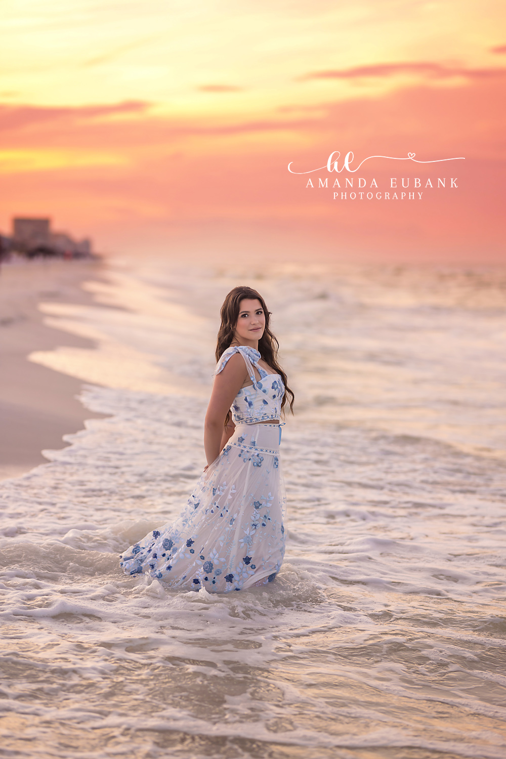Standing in Warm Sea Foam | Tampa Senior Photographer A senior in a floral maxi dress standing in warm sea foam at golden hour during a senior portrait session in Tampa, Florida.