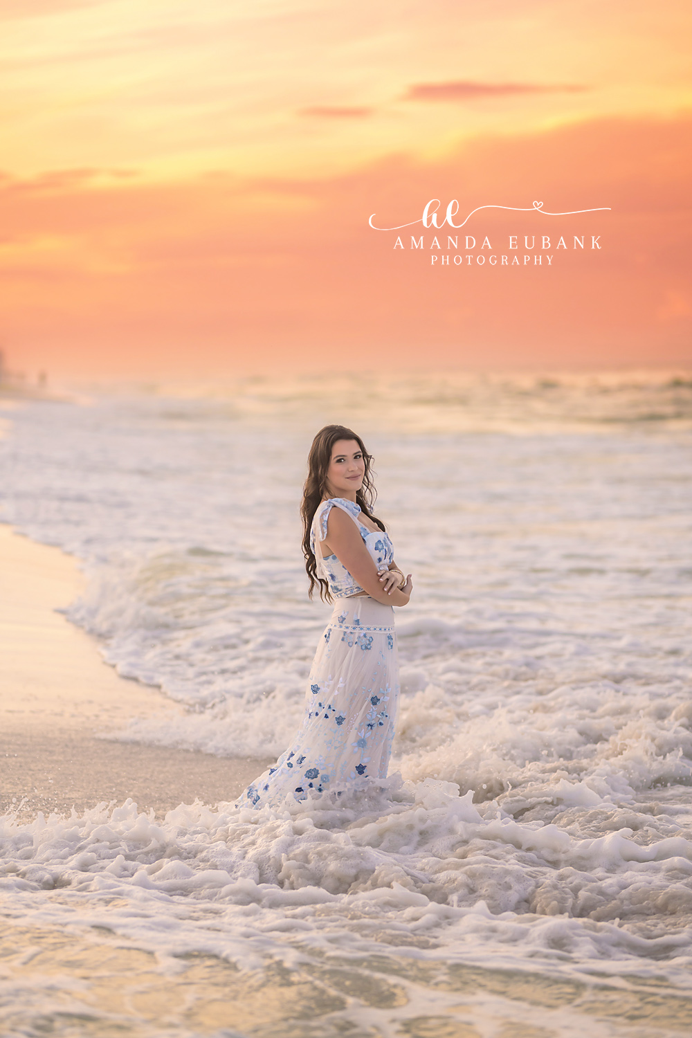 Sea Foam and a Floral Maxi — Tampa Bay Senior Photography A senior in a floral maxi dress standing in swirling foam at sunset at a beach senior session in Tampa, FL.