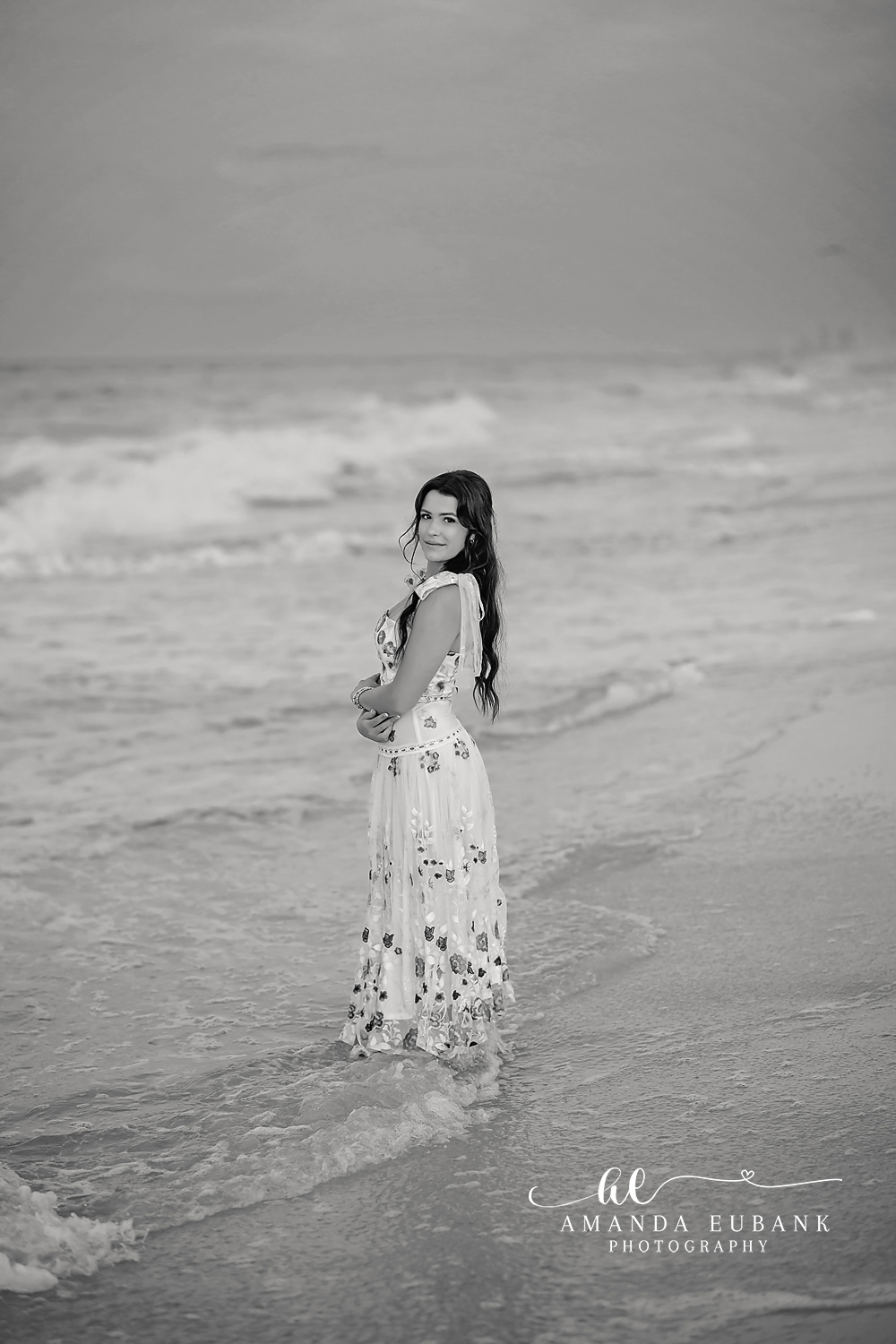 Black and White in the Surf | Beach Senior Session in Tampa, Florida Senior pictures in Tampa Bay showing a black and white portrait of a senior in a maxi dress standing in the surf.